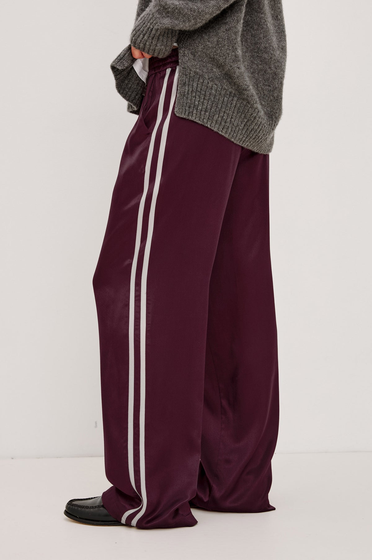 Merida Pant in Satin Back Crepe With Elastic Waistband, Side Pockets, and Wide Legs With Double Side Stripes in Wine Colorway - Lower Body Crop Side View Featured on Model