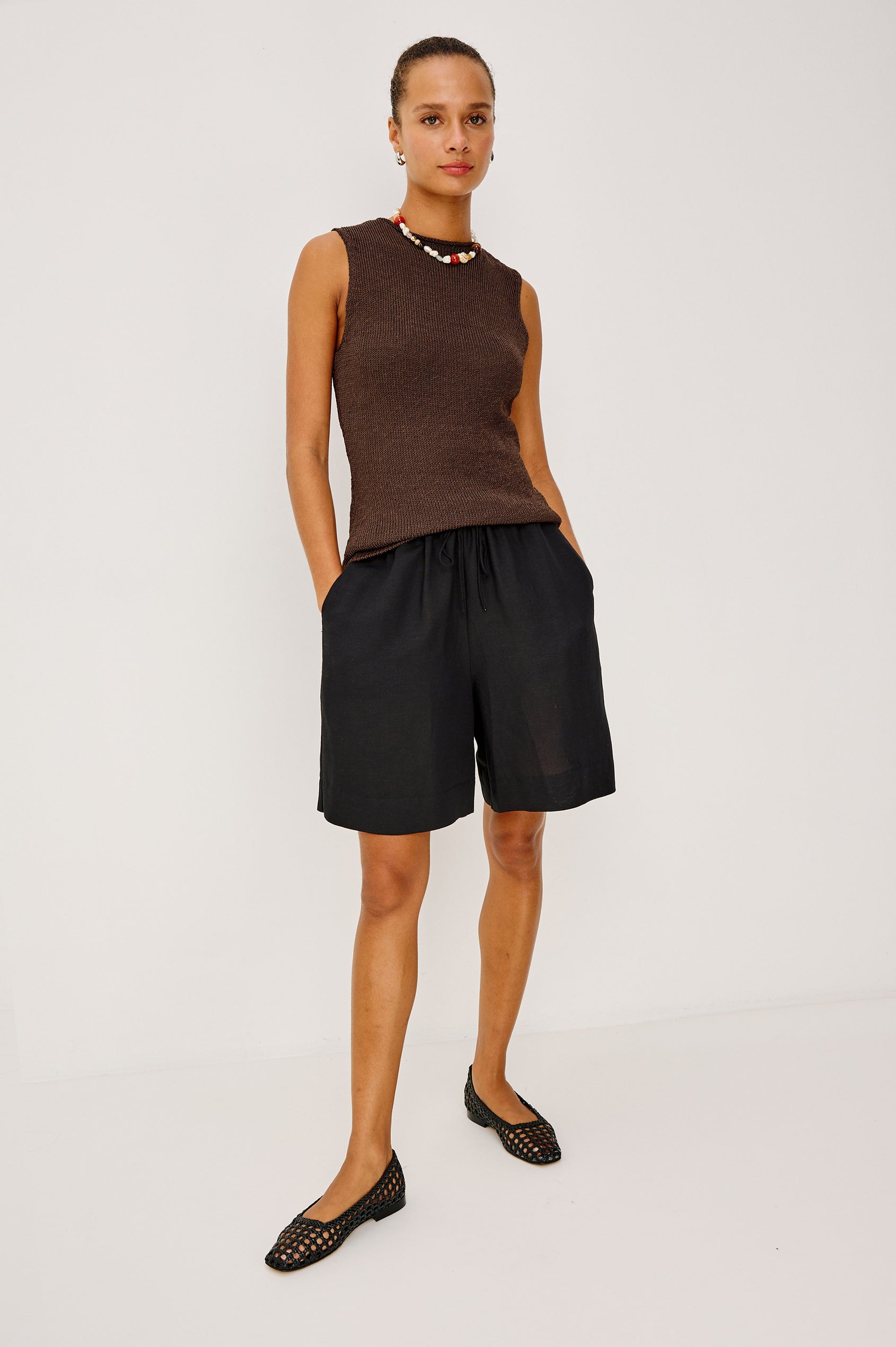 Merit Sleeveless Top in Viscose Blend Knit With Rolled Neckline, and Relaxed Body-Skimming Fit in Espresso Colorway - Full Body Front View Featured on Model