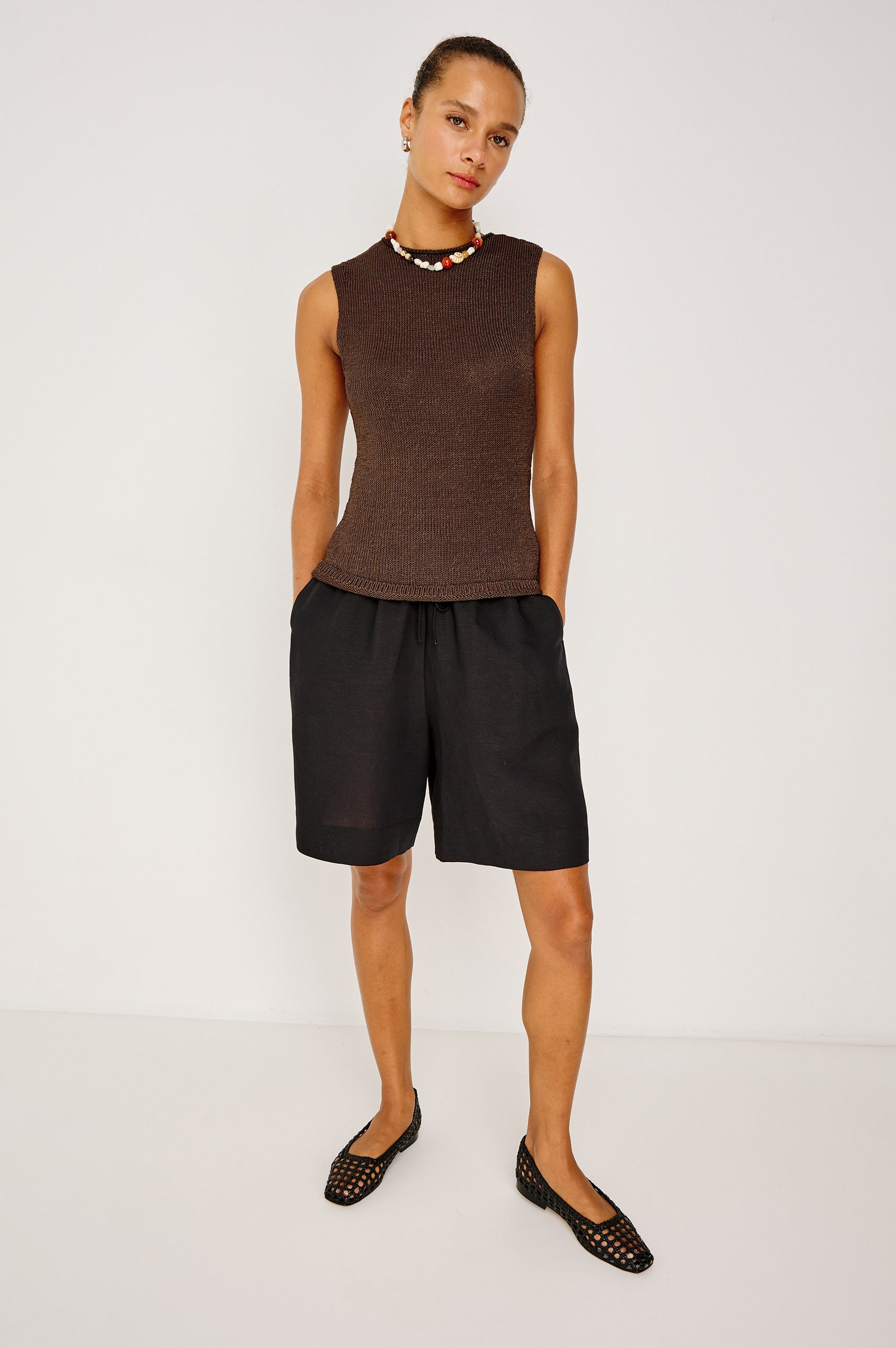 Merit Sleeveless Top in Viscose Blend Knit With Rolled Neckline, and Relaxed Body-Skimming Fit in Espresso Colorway - Full Body Front View Featured on Model