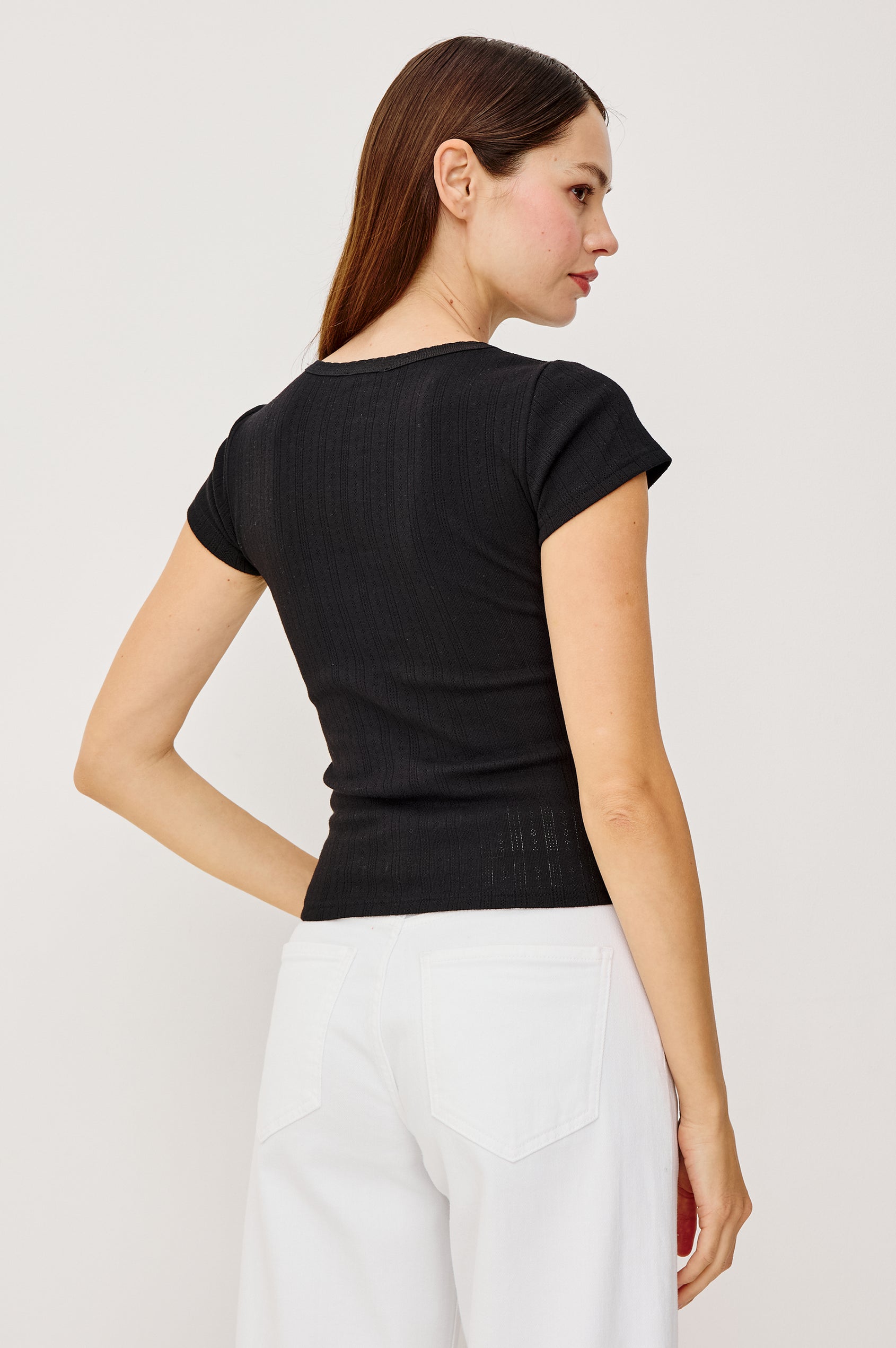 Mickey Fitted Crewneck Short Sleeve Baby Tee With Pleated Rib Pointelle Detailing in Black Colorway - Upper Body Back View Stylized Featuerd on Model