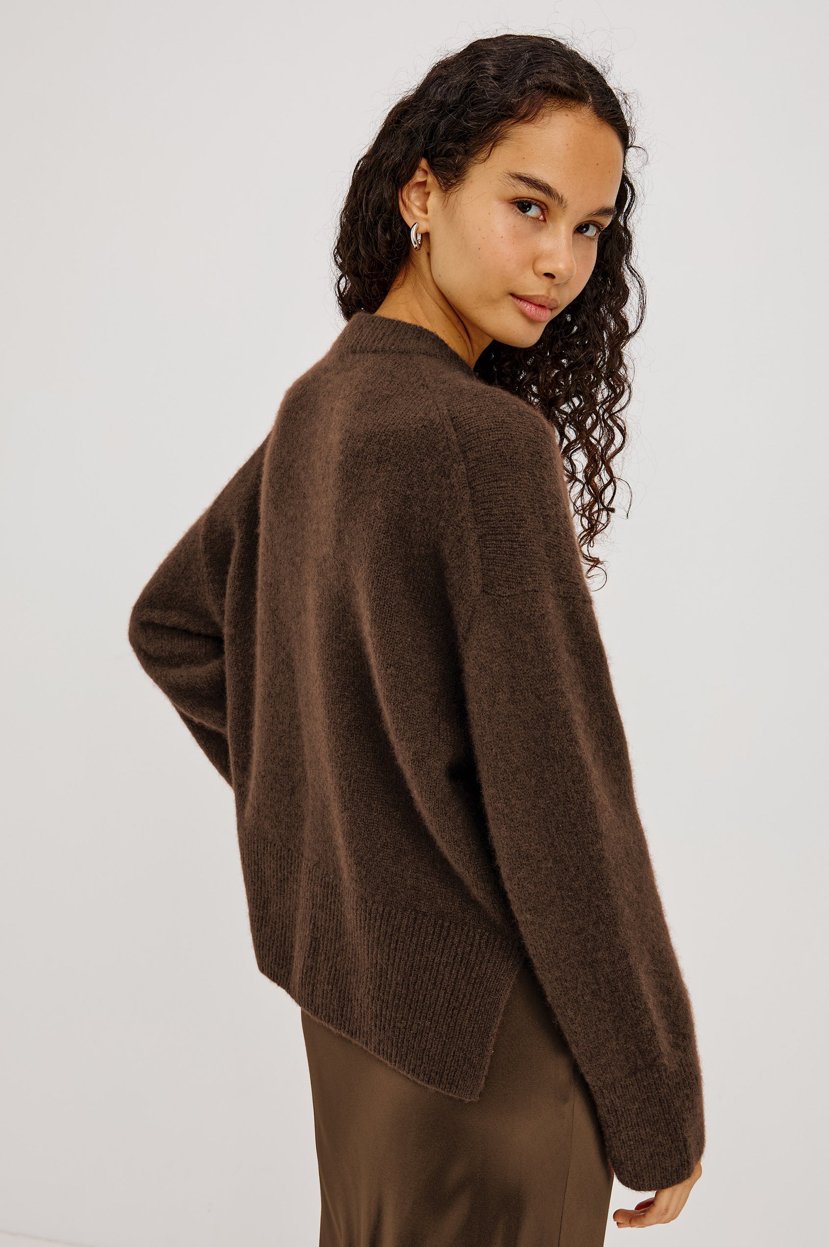 Miranda Sweater in Cashmere-Silk Blend With Relaxed Boxy Fit, Mock Neck, Drop Shoulders, and Side Slits at Hem in Chocolate Colorway - Upper Body Side View Featured on Model