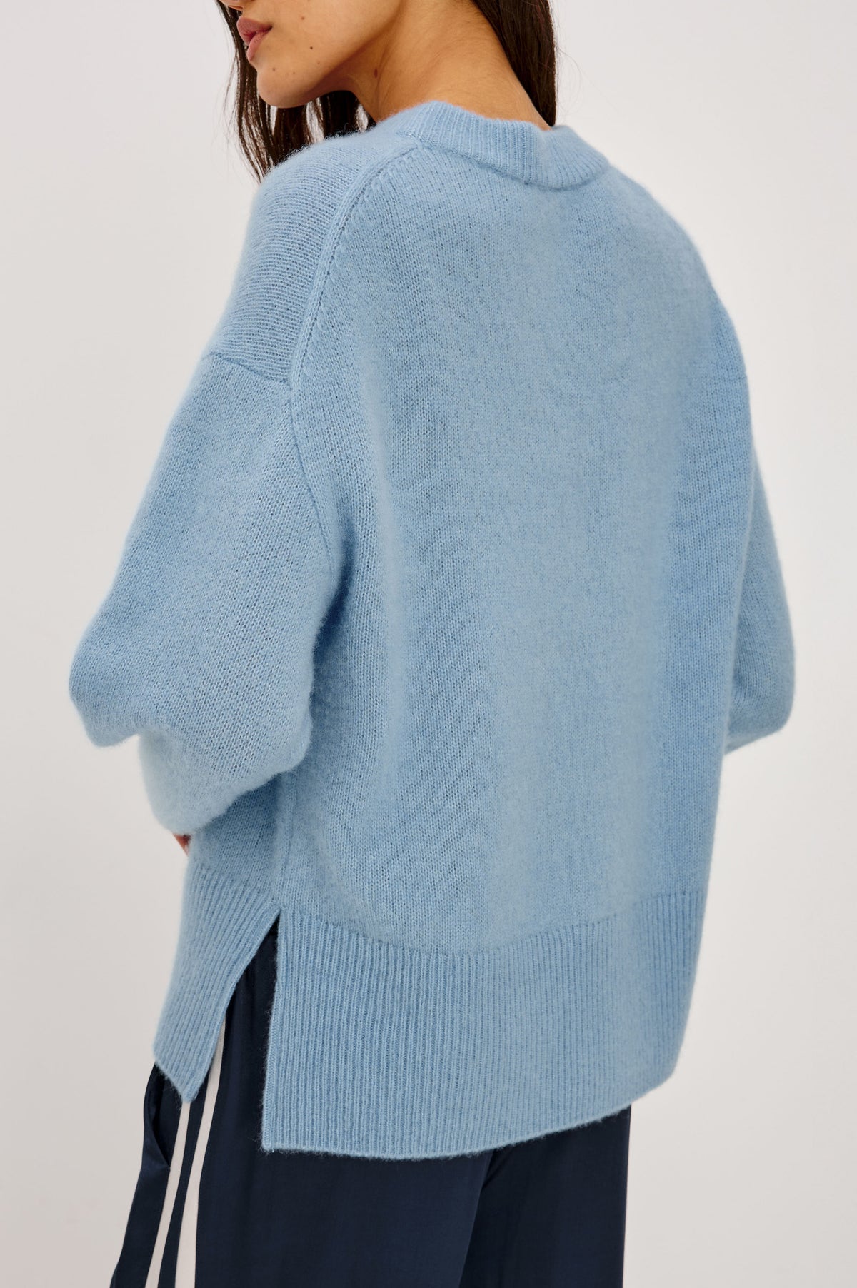 Miranda Sweater in Cashmere-Silk Blend With Relaxed Boxy Fit, Mock Neck, Drop Shoulders, and Side Slits at Hem in Fjord Blue Colorway - Upper Body Back View Featured on Model.