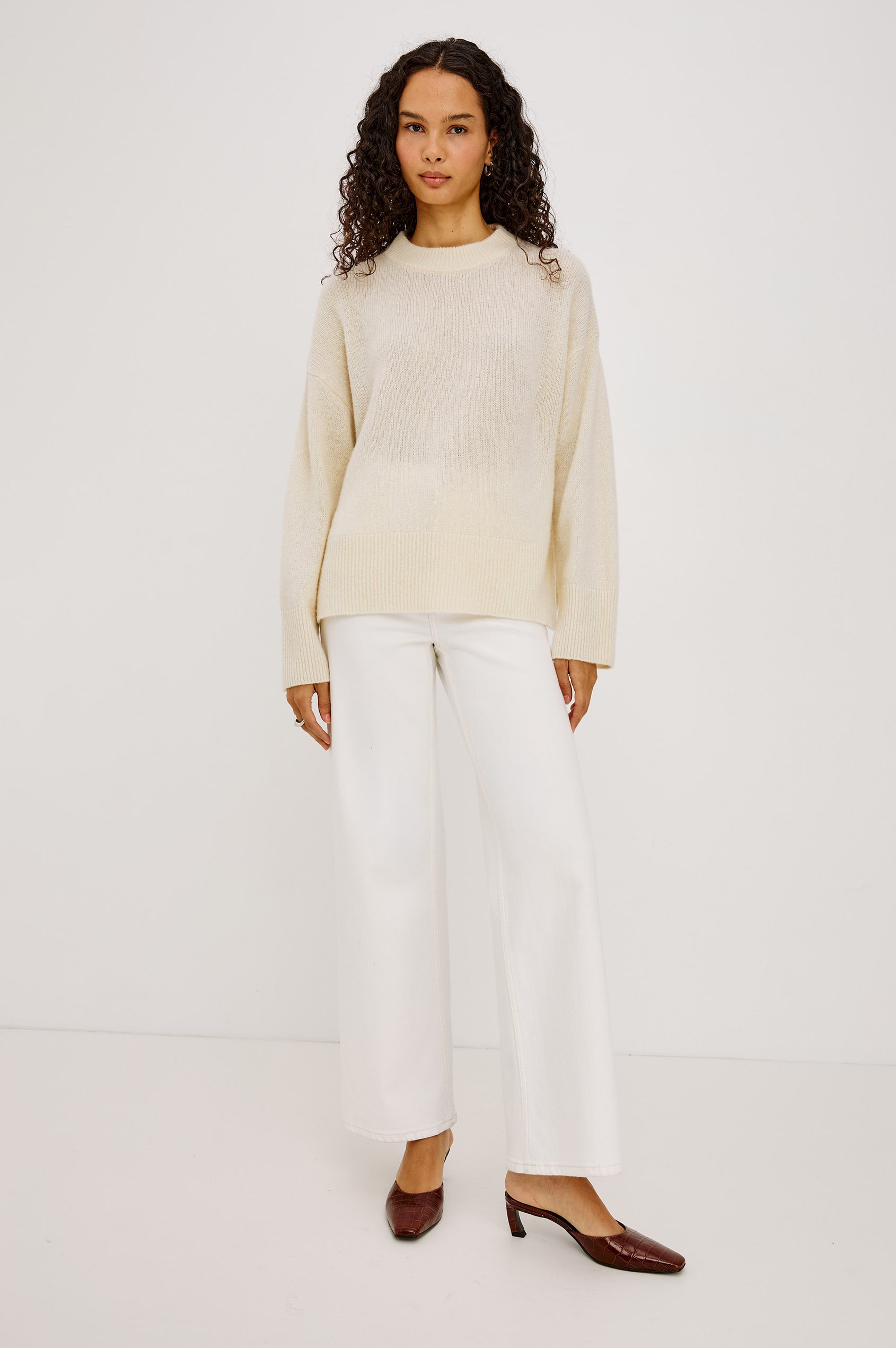 Miranda Sweater in Cashmere-Silk Blend With Relaxed Boxy Fit, Mock Neck, Drop Shoulders, and Side Slits at Hem in Ivory Colorway - Full Body Front View Featured on Model