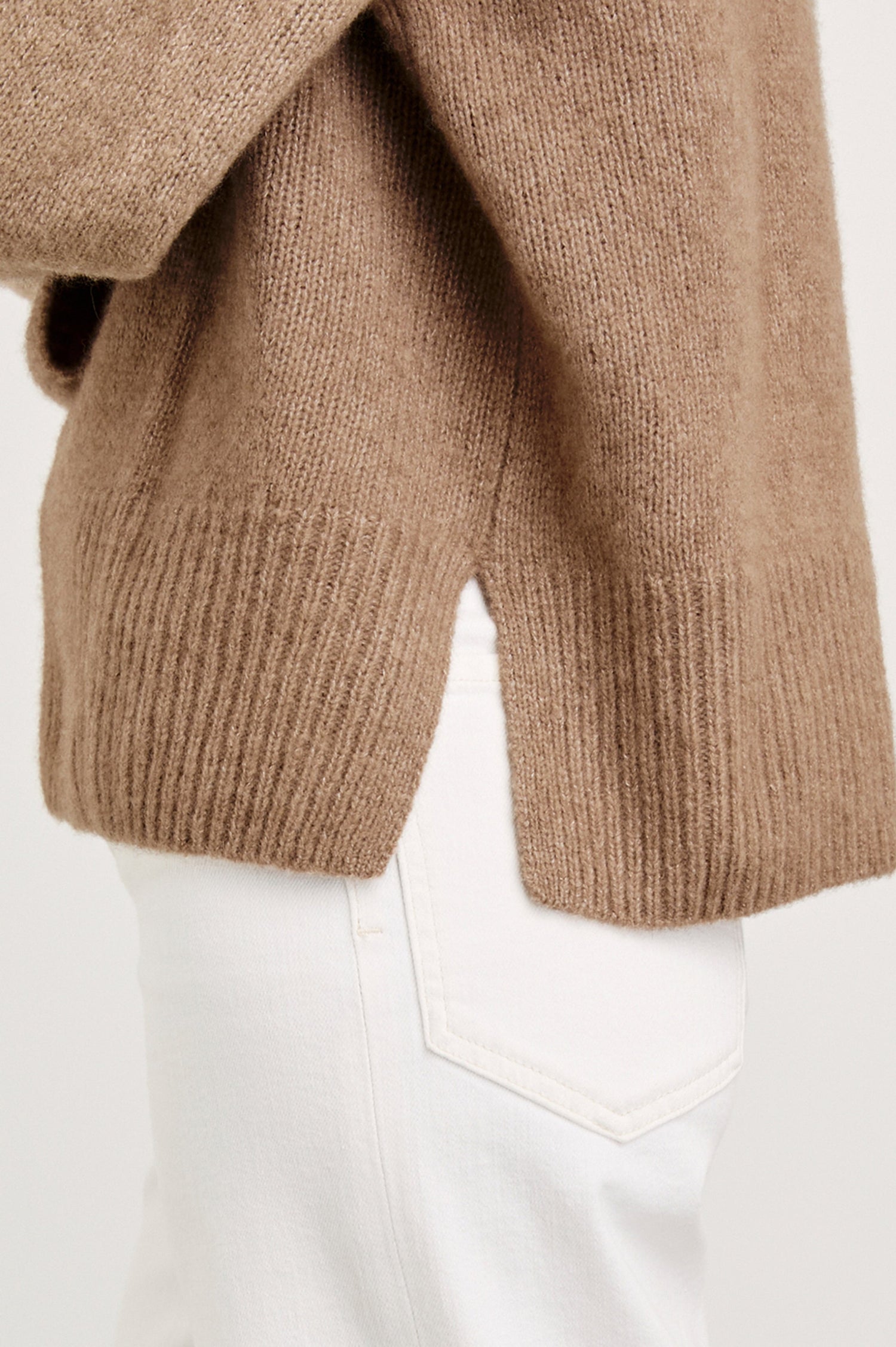Miranda Long-Sleeve Sweater with a Mock Neck, Side Slits, and Ribbed Trim in Oatmeal Colorway - Side View Featured on Model