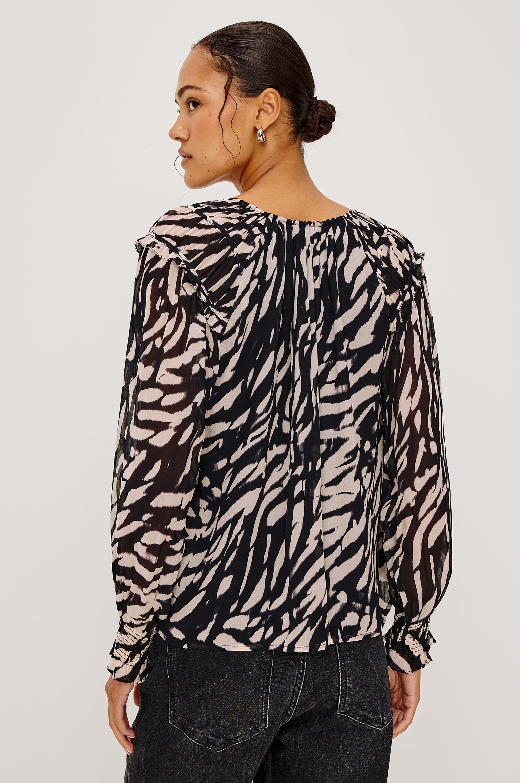 Mirna Blouse in Chiffon With Self-Tie V-Neckline, Loose Boxy Fit, Ruffle Trim, Balloon Sleeves with Smocked Cuffs in Ivory Tiger Stripe Colorway - Upper Body Back View Featured on Model
