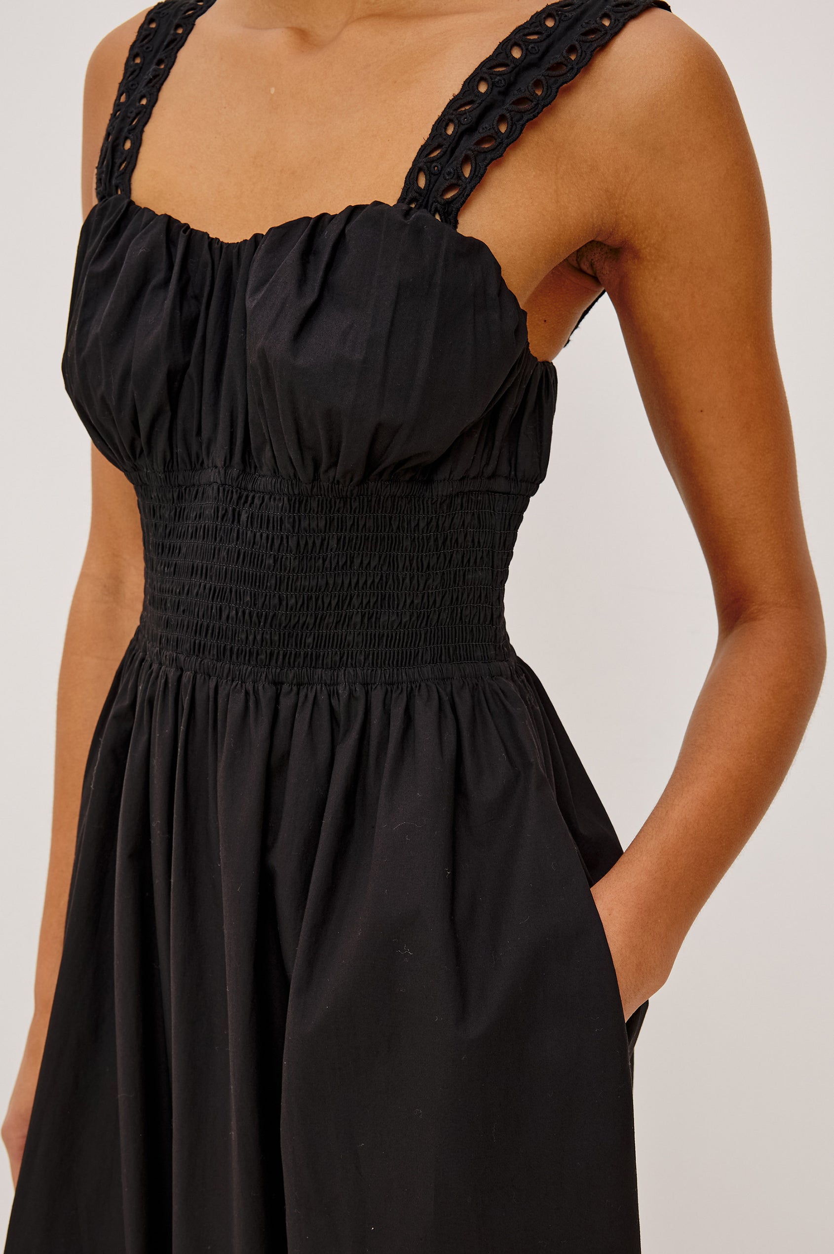 Moira Midi Dress in Cotton Poplin With Wide Embroidered Shoulder Straps, Soft Sweetheart Neckline, Smocked Empire Waist, Fully Lined Skirt With Floral Cutwork at Hem in Black Colorway - Upper Body Front Close Up View Featured on Model