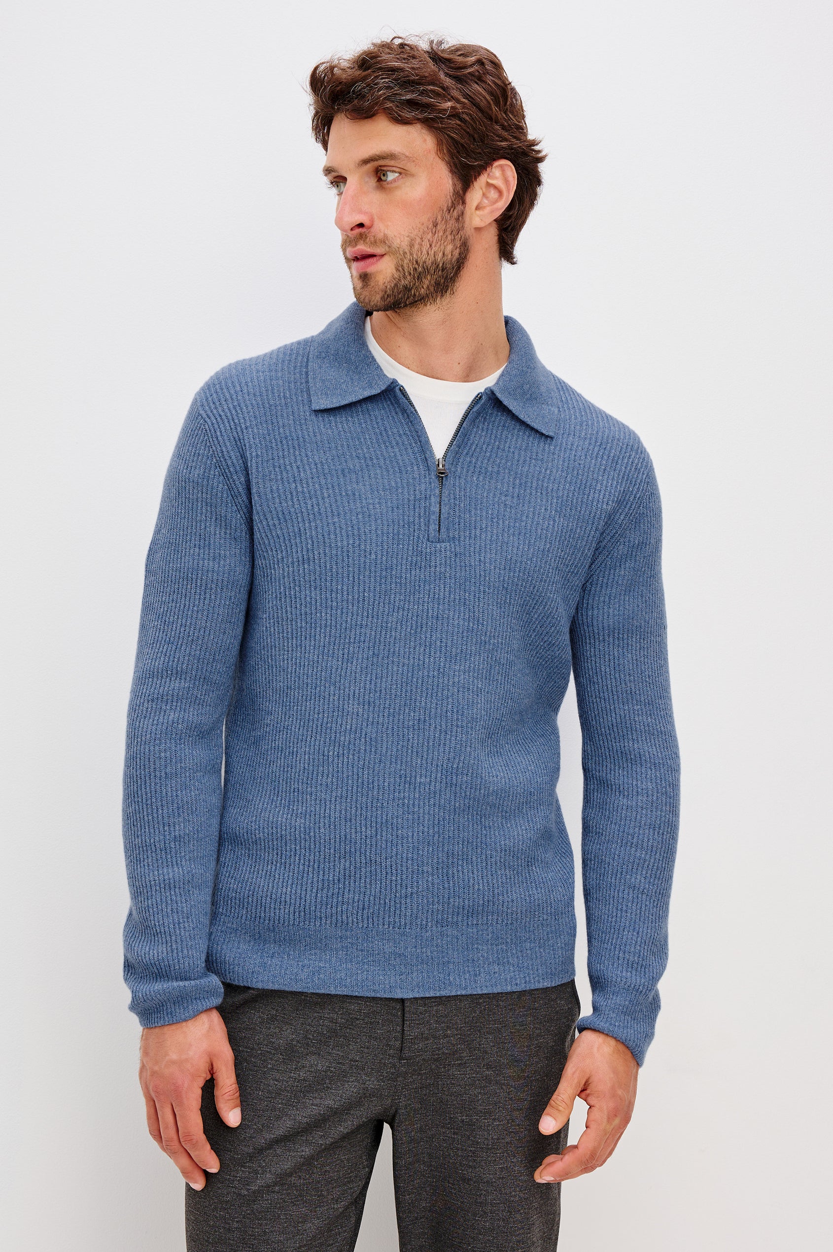 Monty is a collared quarter-zip long sleeved sweater in Cerulean Melange colorway. Front view featured on model.