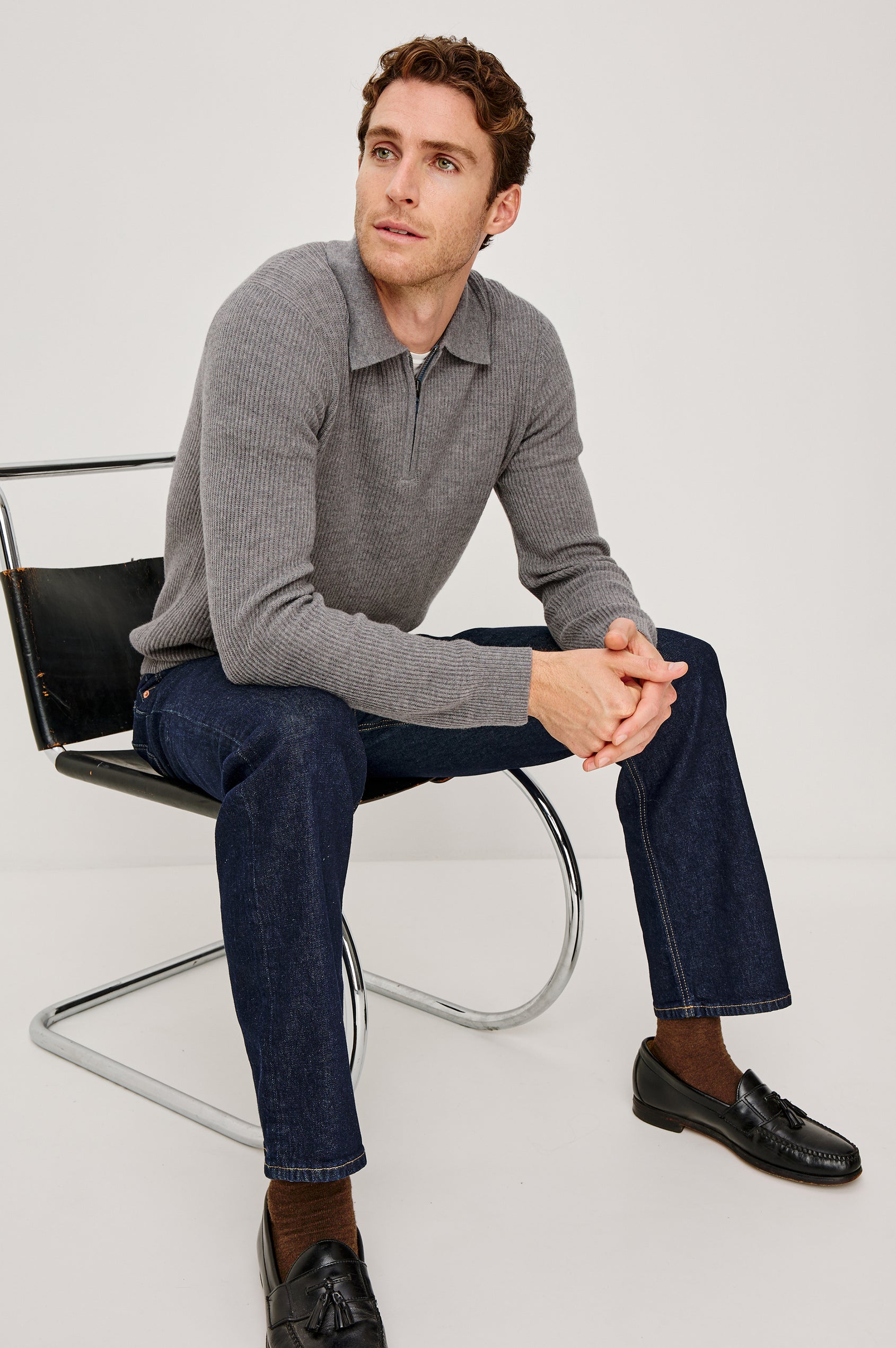 Monty is a collared quarter-zip long sleeved sweater in Finch colorway. Front view featured on seated model.
