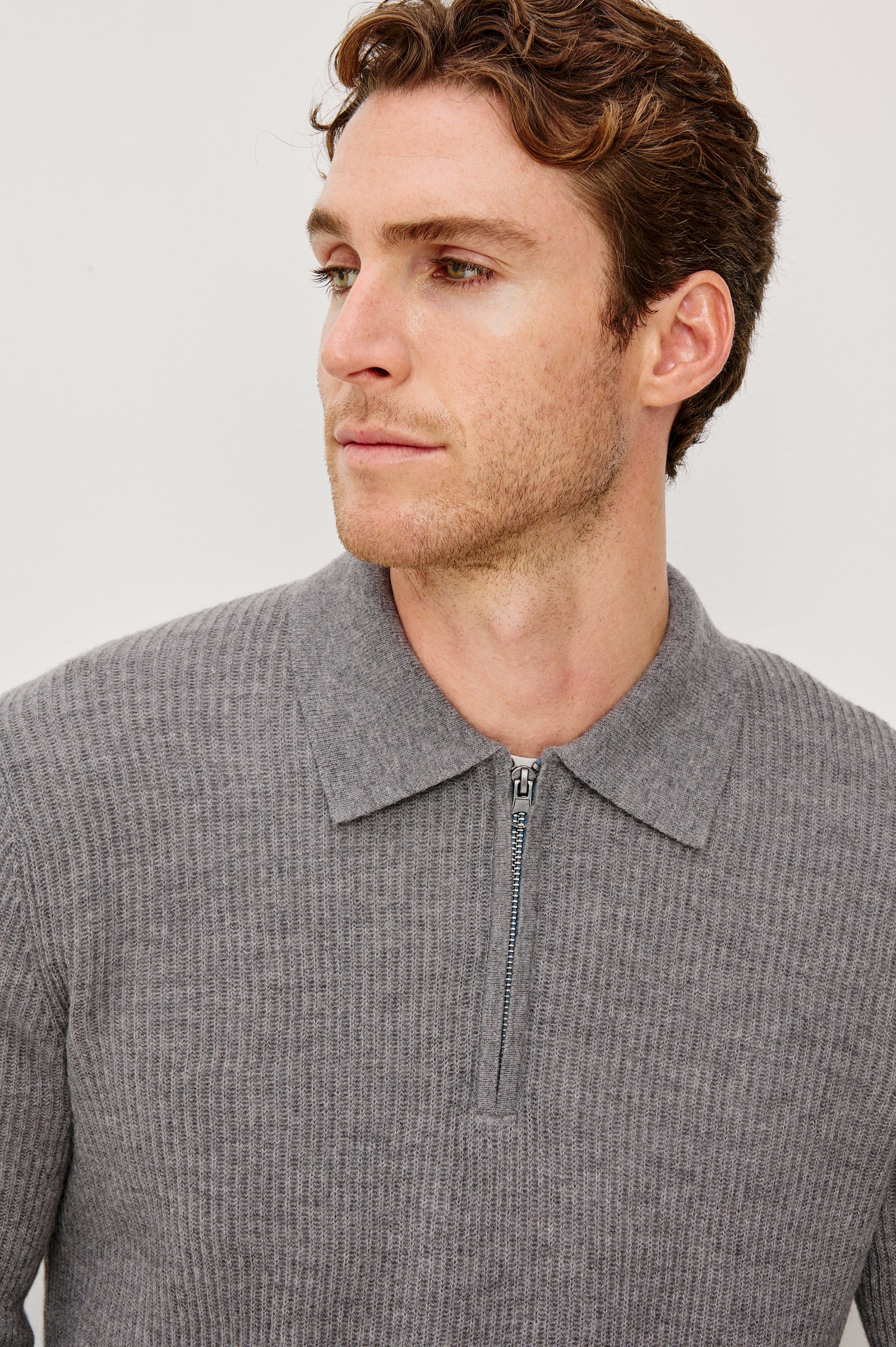 Monty is a collared quarter-zip long sleeved sweater in Finch colorway. Front detail view featured on model.