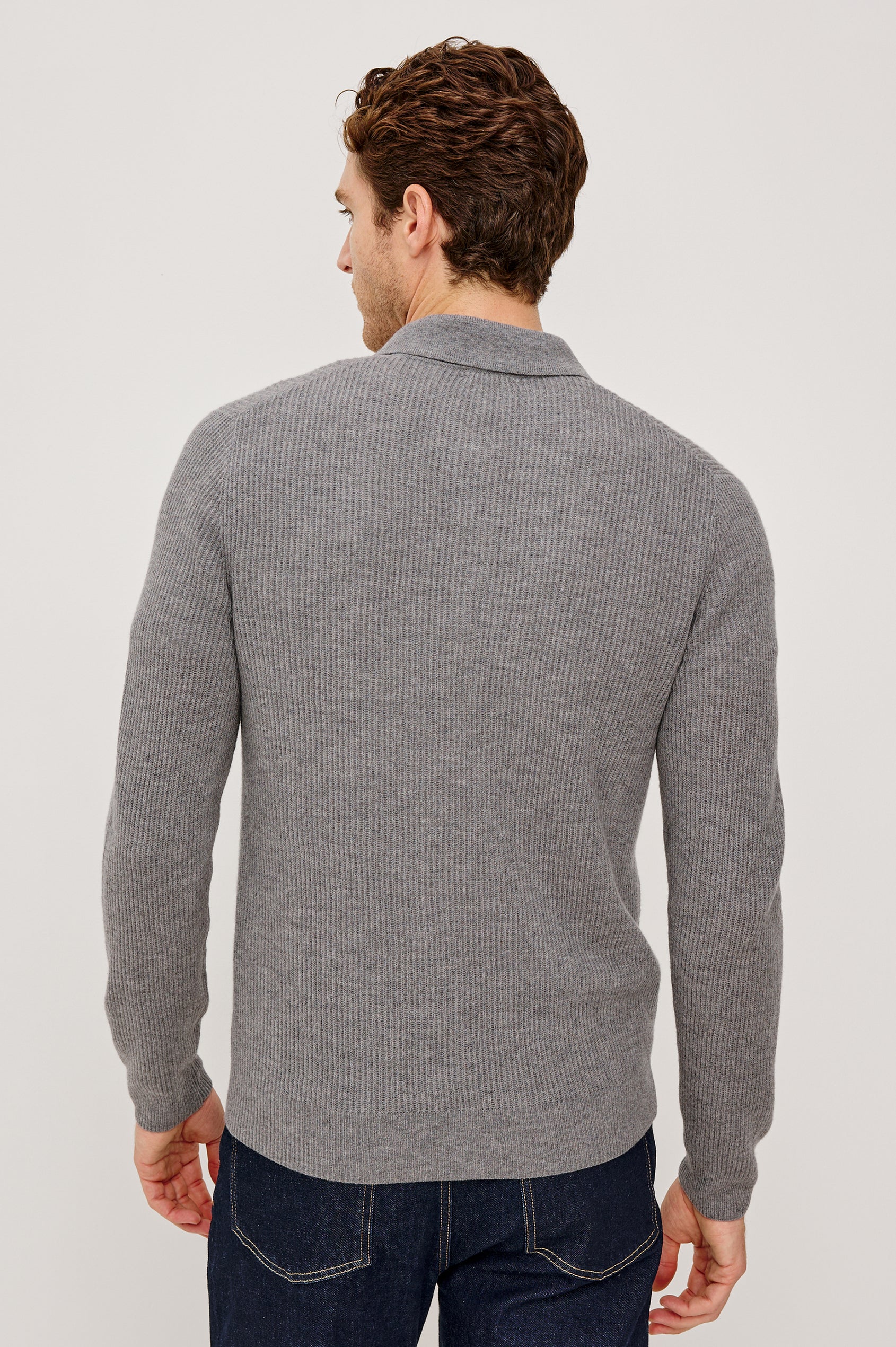 Monty is a collared quarter-zip long sleeved sweater in Finch colorway. Back view featured on the model.