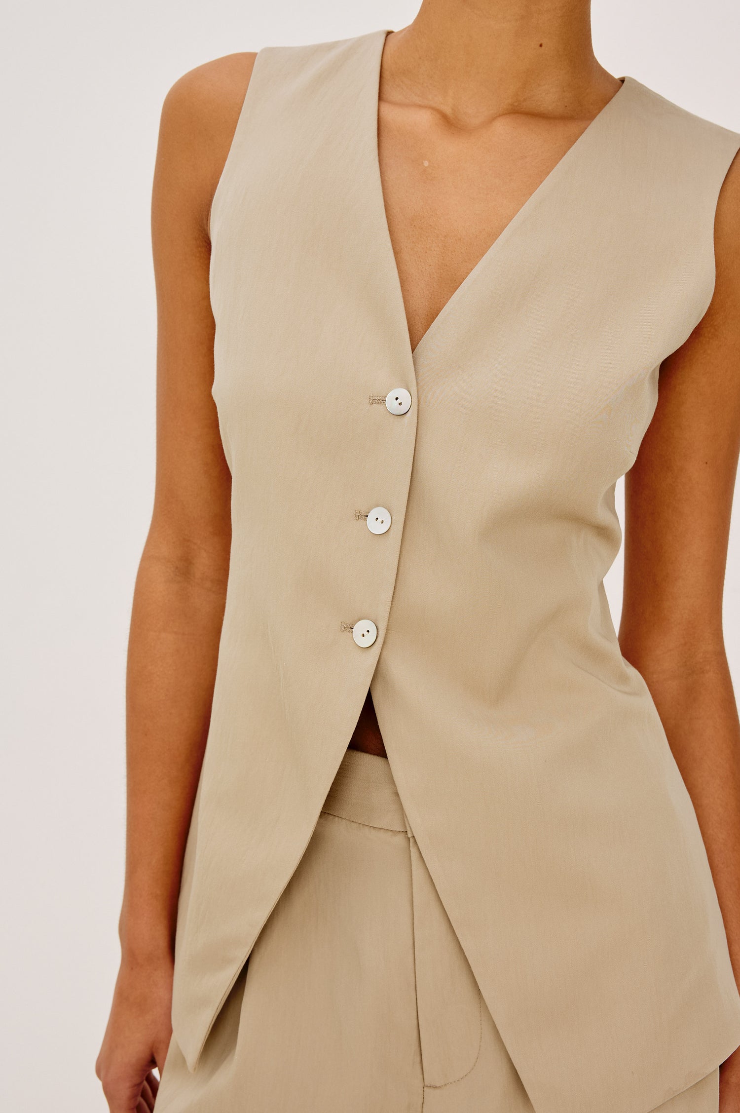 Mylah Vest in Viscose Suiting With V-Neckline, Front Buttons, and Slightly-Loose Fit Tapered at Waist in Almond Colorway - Upper Body Front View Featured on Model