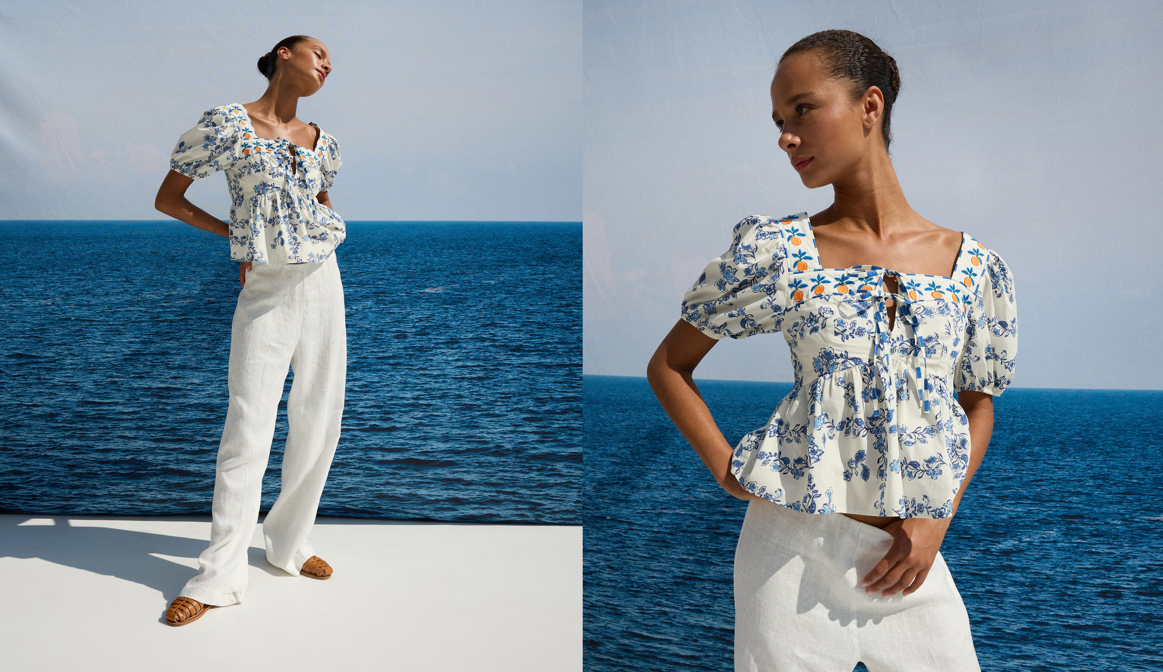 Woman wearing a floral blouse and white pants by the ocean