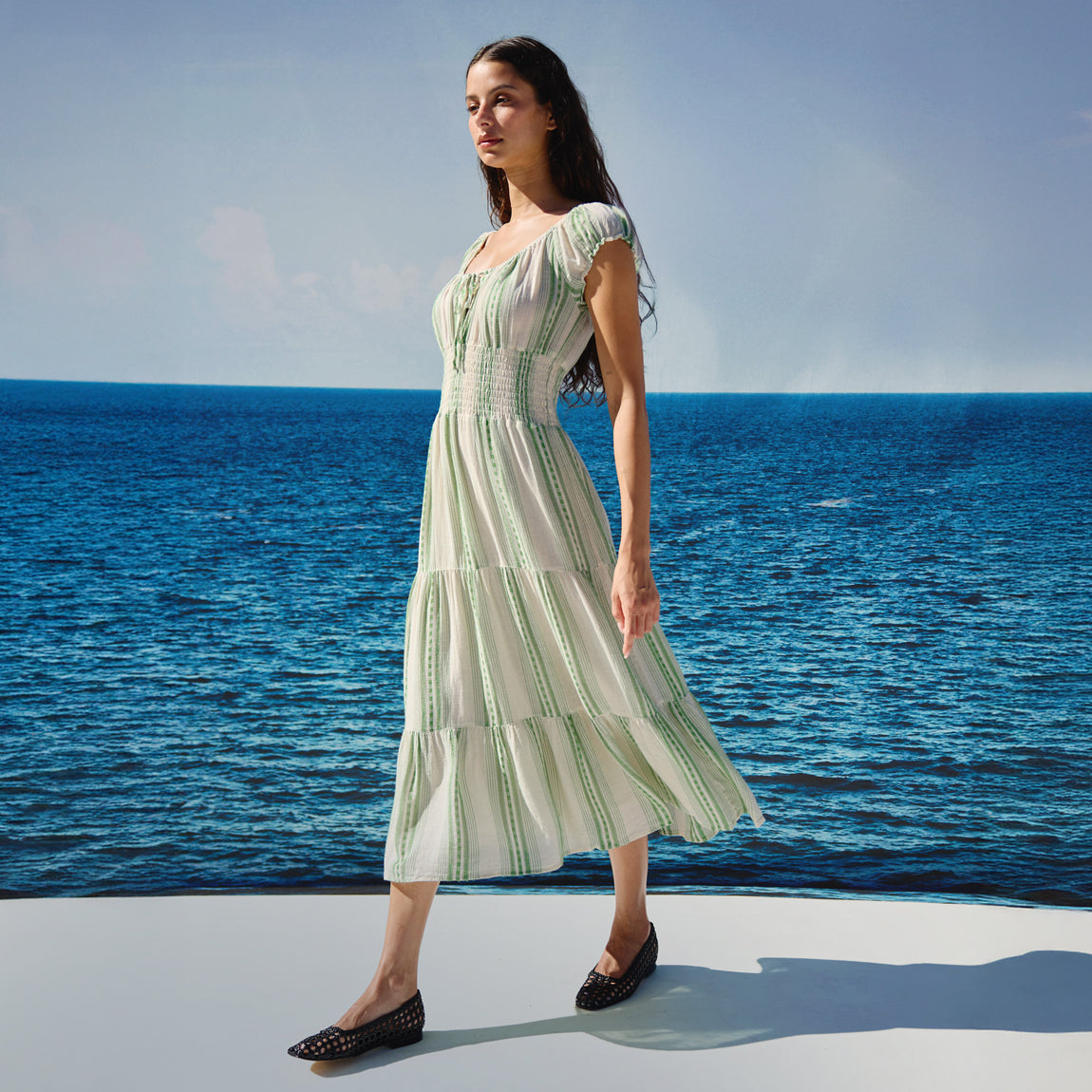 Woman wearing a green and white striped dress