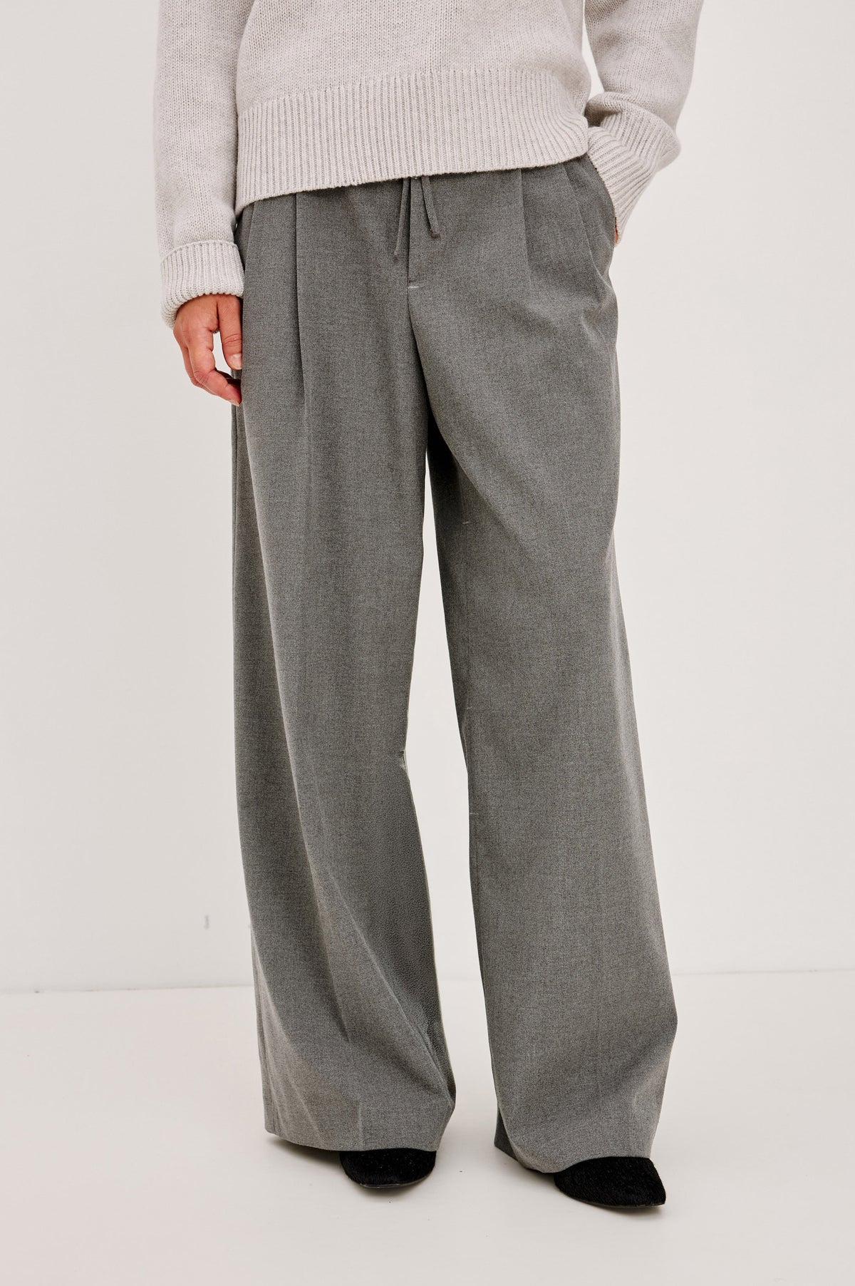 Nando Pant in Drapey Suiting Blend With High Waist, Wide, Relaxed Legs, and Drawstring Ties in Heather Charcoal Colorway - Front Crop View Feature on Model.
