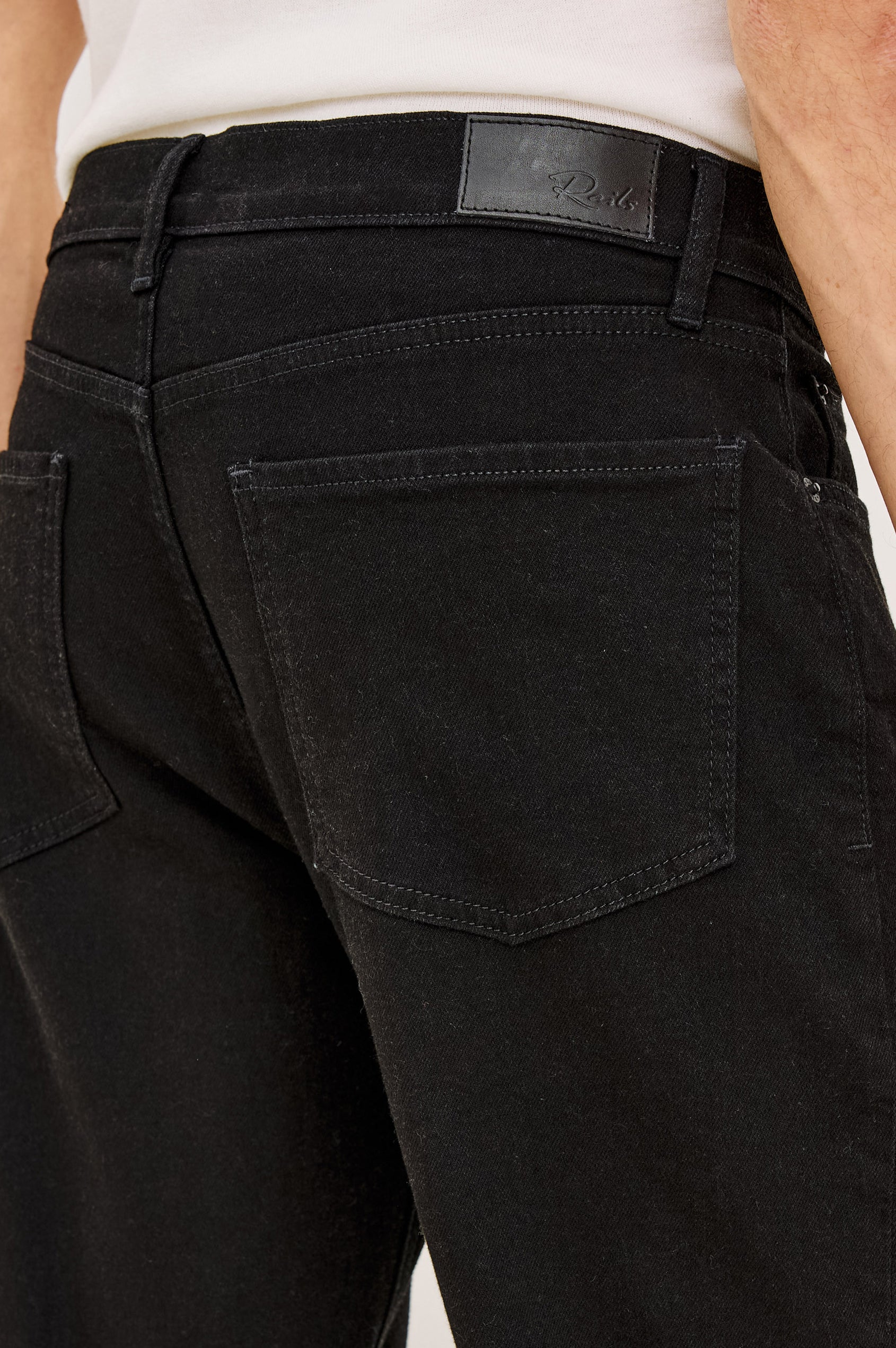 Nash Straight Leg Jean in Rigid Denim With Vintage-Inspired Button Fly in Dark Black Colorway - Close-up back view featured on model.