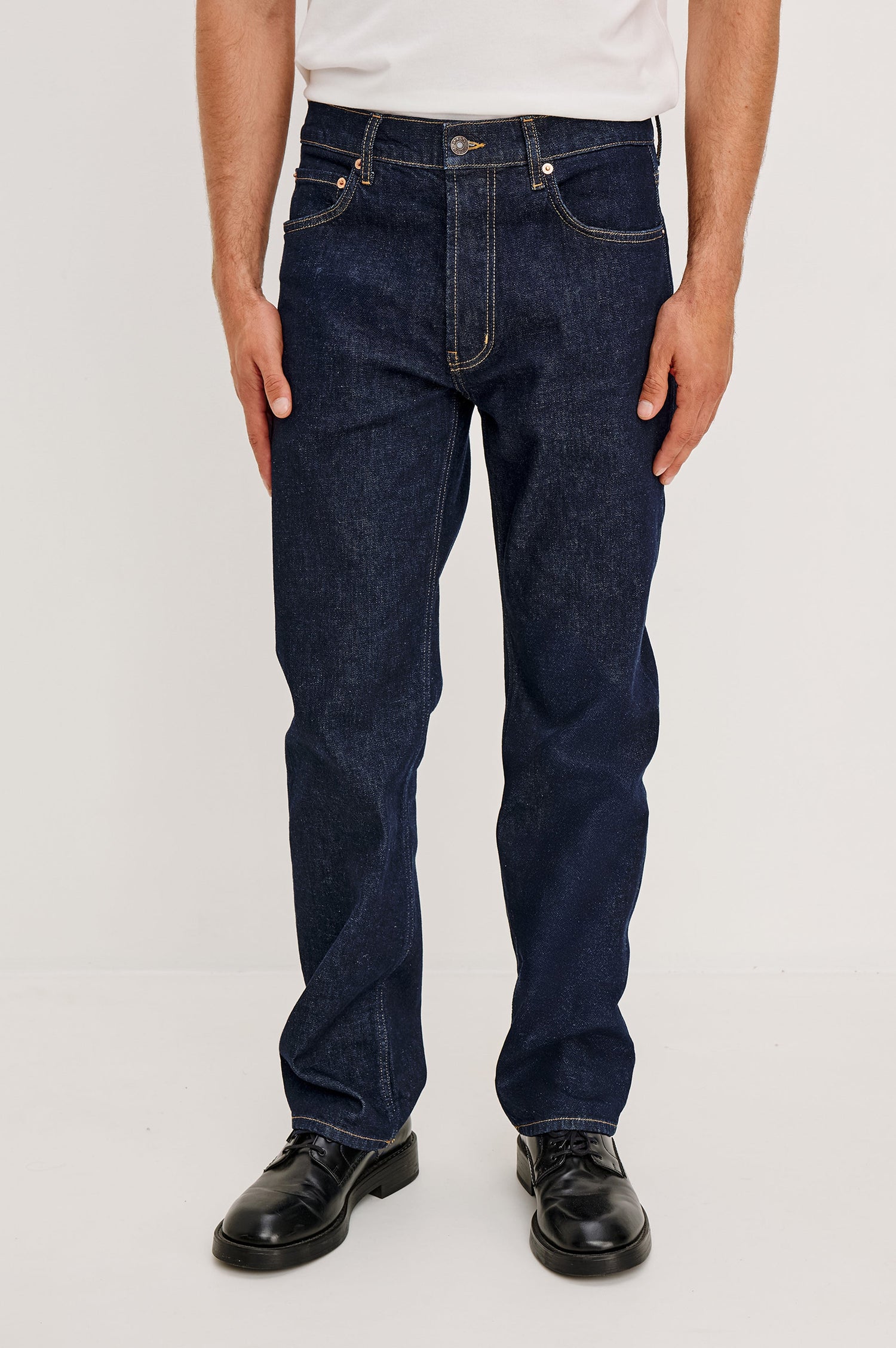 Nash is a straight leg 5-Pocket denim jean a zip fly and button closure as well as rivets in a Rinse Wash. Front view featured on model.