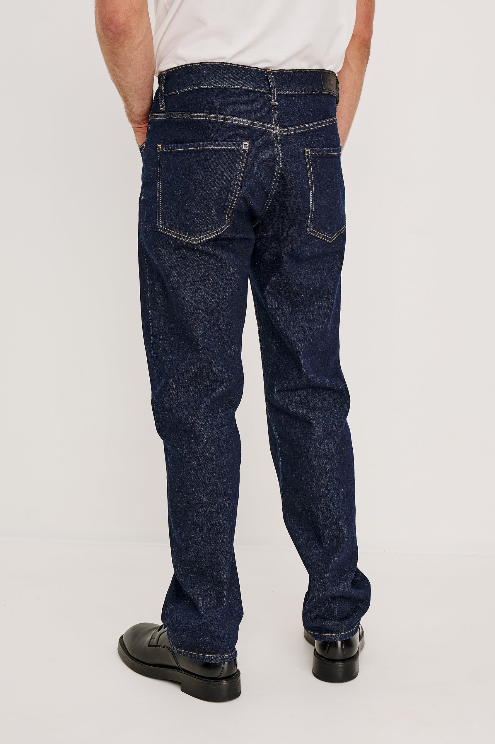 Nash is a straight leg 5-Pocket denim jean a zip fly and button closure as well as rivets in a Rinse Wash. Back full body view featured on model.
