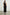 Navi Sleeveless Midi Dress with a Halter Neckline with a Back Tie Keyhole, and a Wrap Skirt with a Side Tie Closure in Black Colorway - Back Full Body View Featured on Model  
