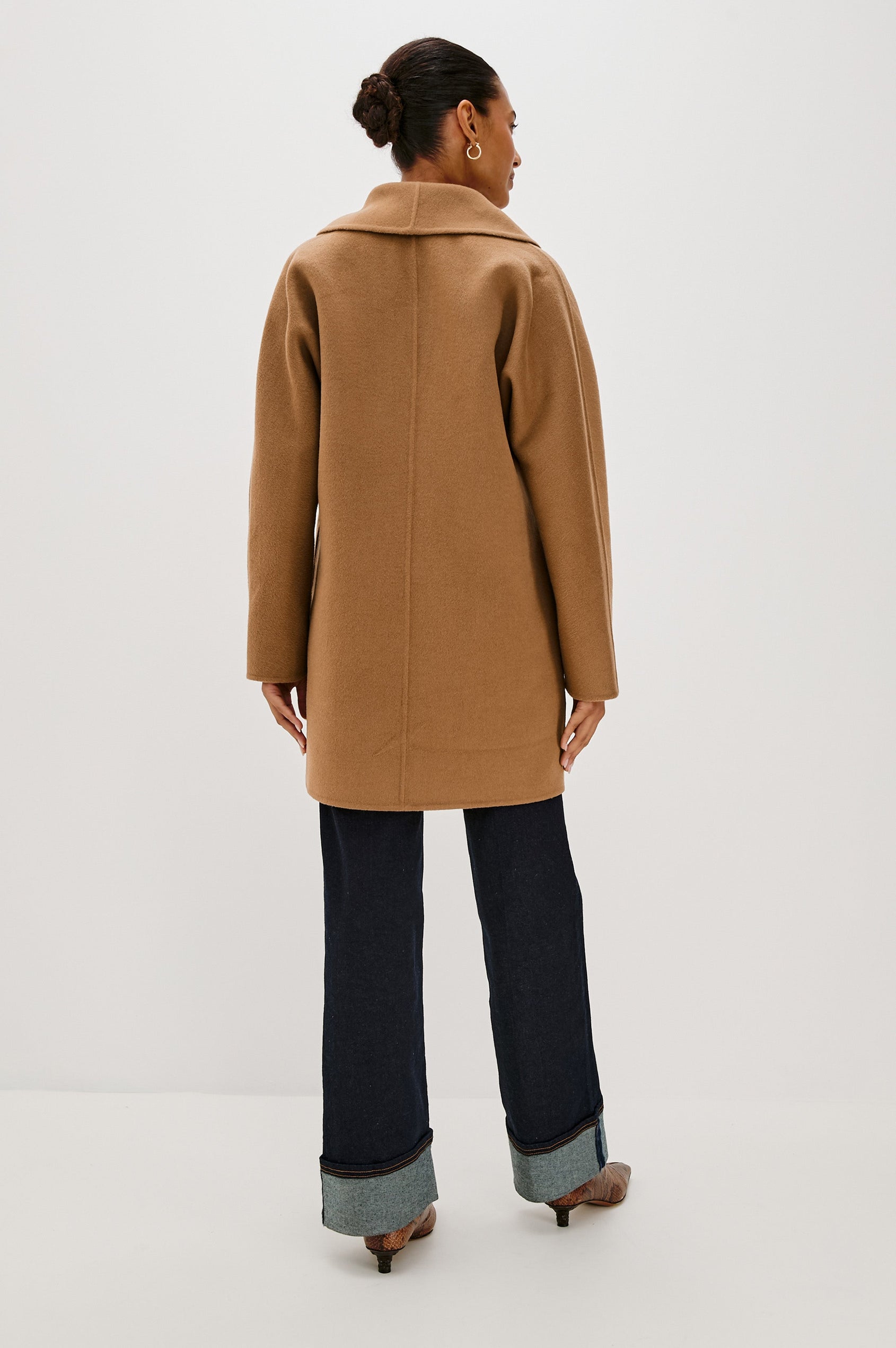 Nily Mid-Thigh Length, Double-Breasted Coat with Two Button Closure, Two Front Patch Pockets and a Shaw Collar in Camel Colorway - Back View Featured on Model 