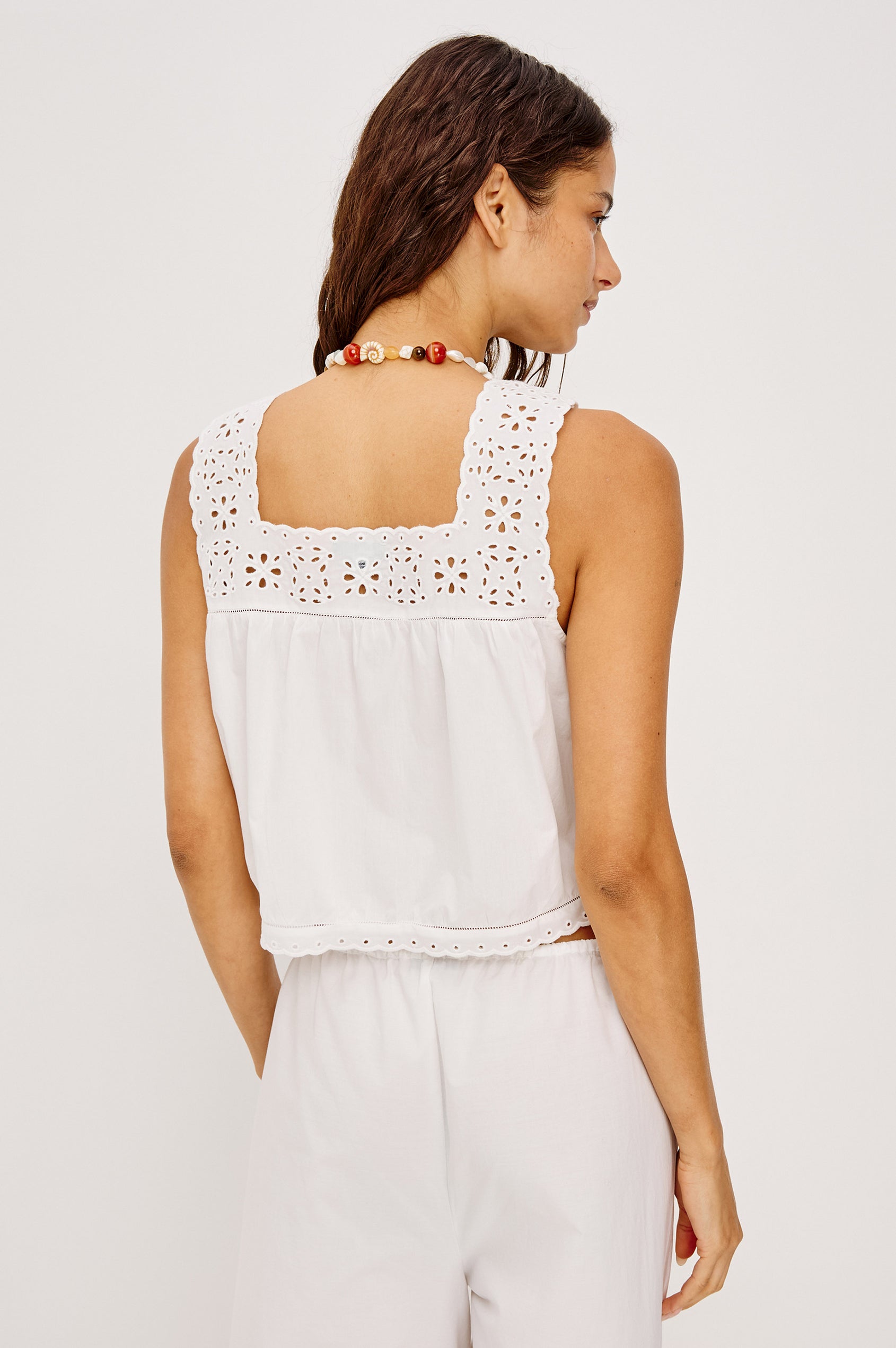 Noemi Sleeveless Top in Cotton Poplin With Square Neckline, Embroidered Shoulder Straps and Yoke, Mini Ladder Trim, Center Button-Loop Closures, and is Unlined in White Colorway - Upper Body Back View Featured on Model