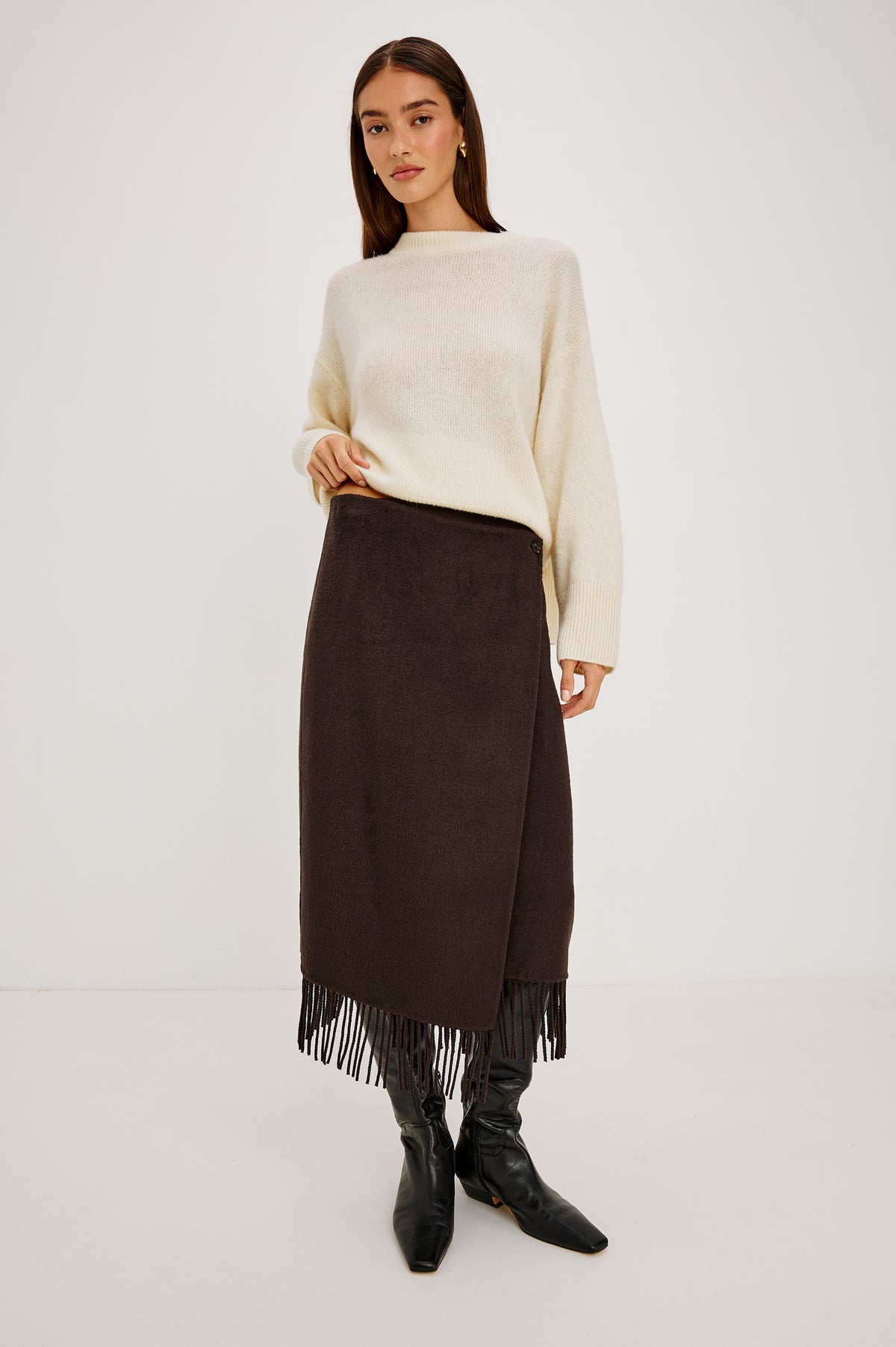 Odette Midi Skirt in Wool Blend With Wrap Design, Hidden Side Button Closure, and Fringe Hem in Chocolate Colorway - Full Body Front View Featured on Model