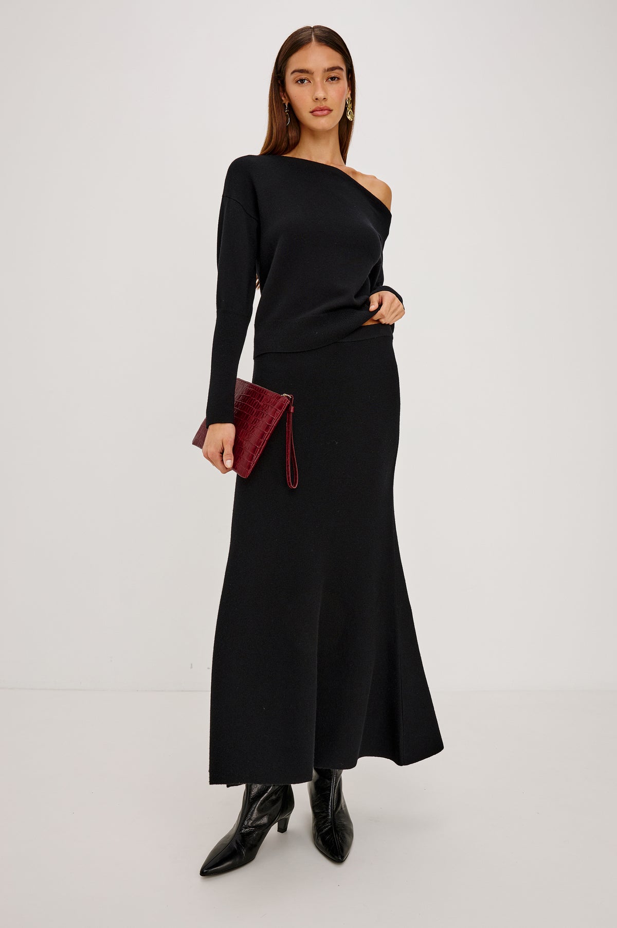 Odita Maxi Skirt in Soft Ribbed Wool Blend Knit With Elastic Waist, and A-Line Silhouette in Black Colorway - Front Full Body View Featured on Model.