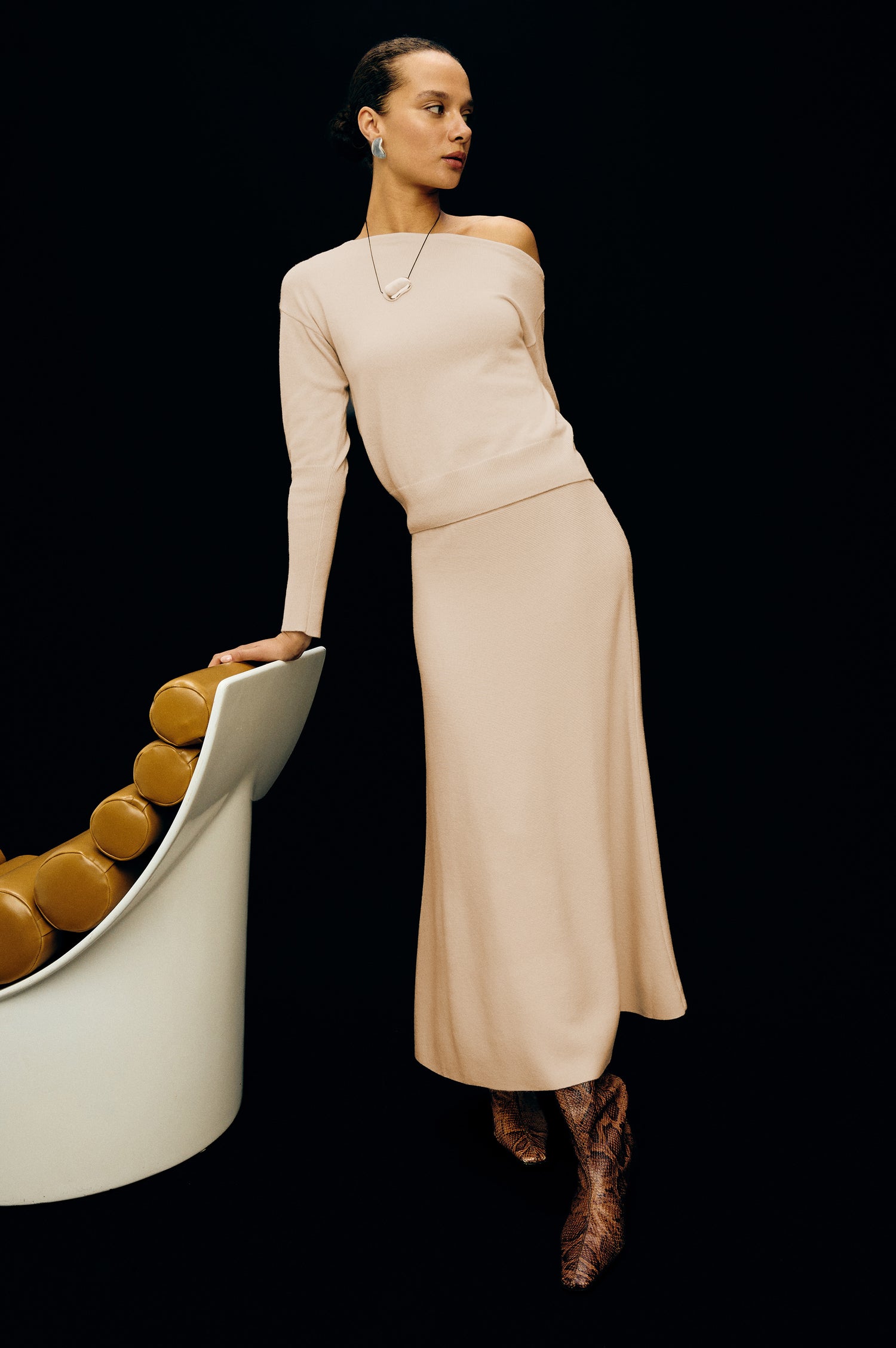 Odita Midi Skirt in Ribbed Wool Blend With High-Waisted Fit, A-Line Silhouette, and Wide Waistband in Ivory Colorway - Full Body Stylized Front View Featured on Model