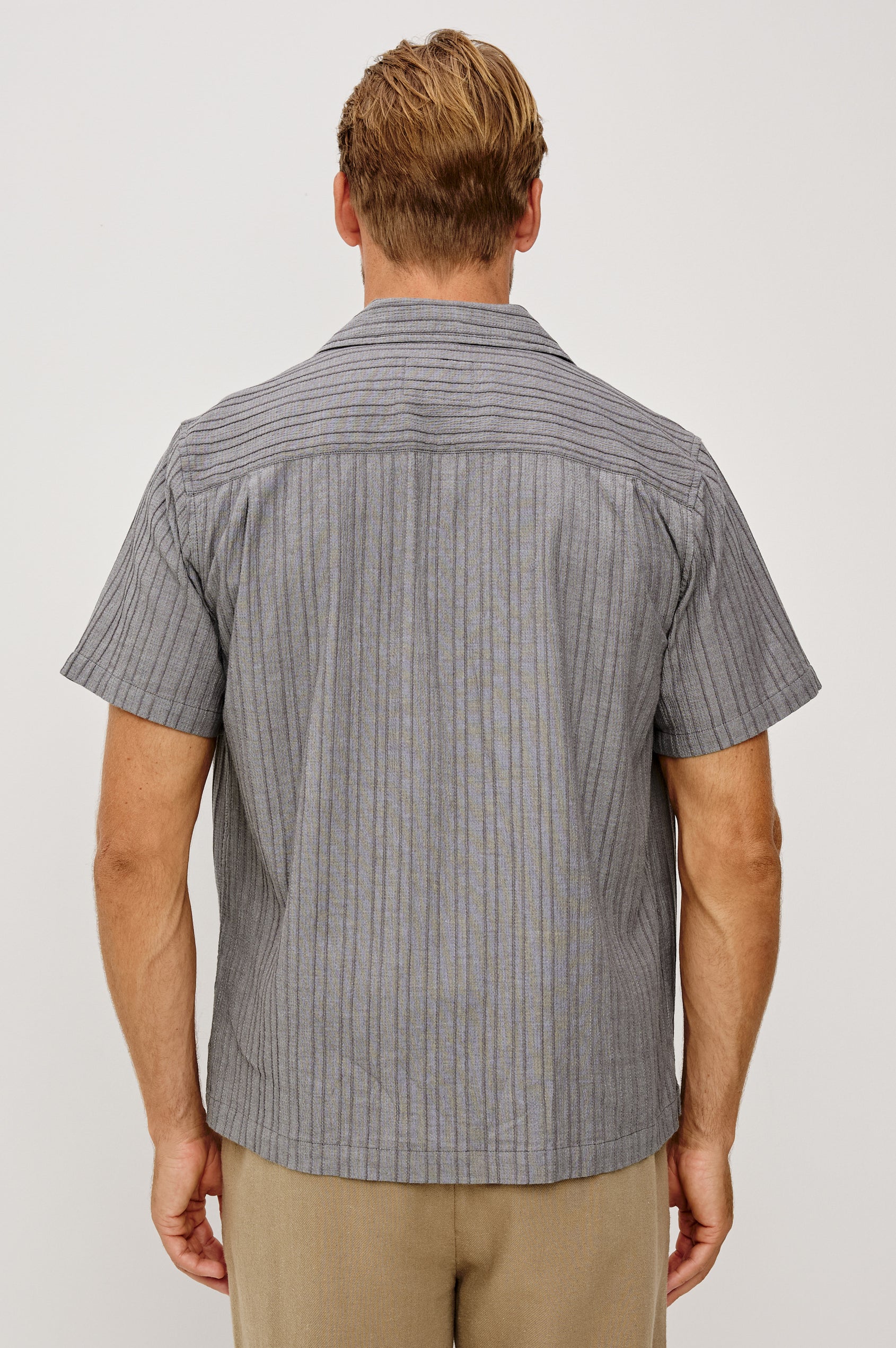 Ohana Button-Up Shirt in Textured Shirting WIth Short Sleeves, Collar, and Relaxed Fit in Charcoal Chambray Colorway - Upper Body Back View Featured on Model