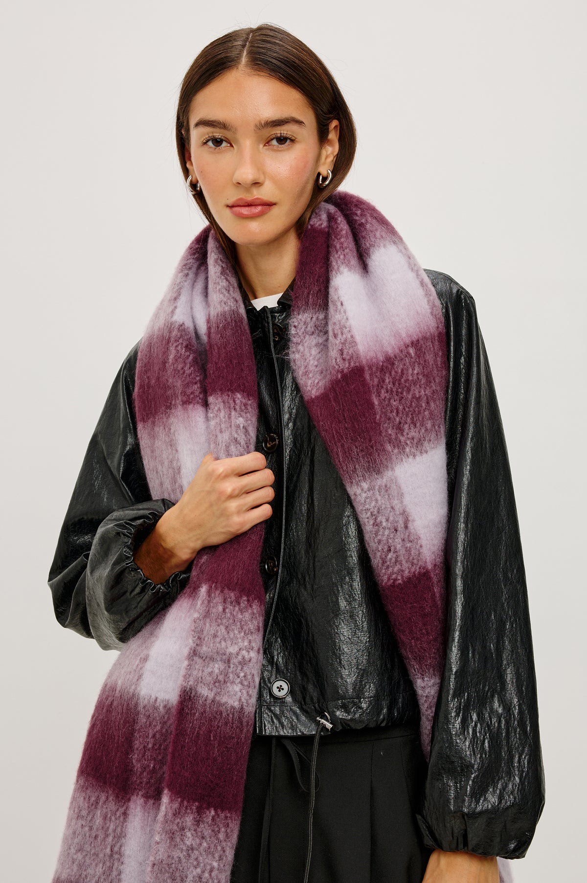 Oslo Oversized Knit Scarf With Fringe Trim in Wine Lilac Check Colorway - Upper Body Front View Featured on Model