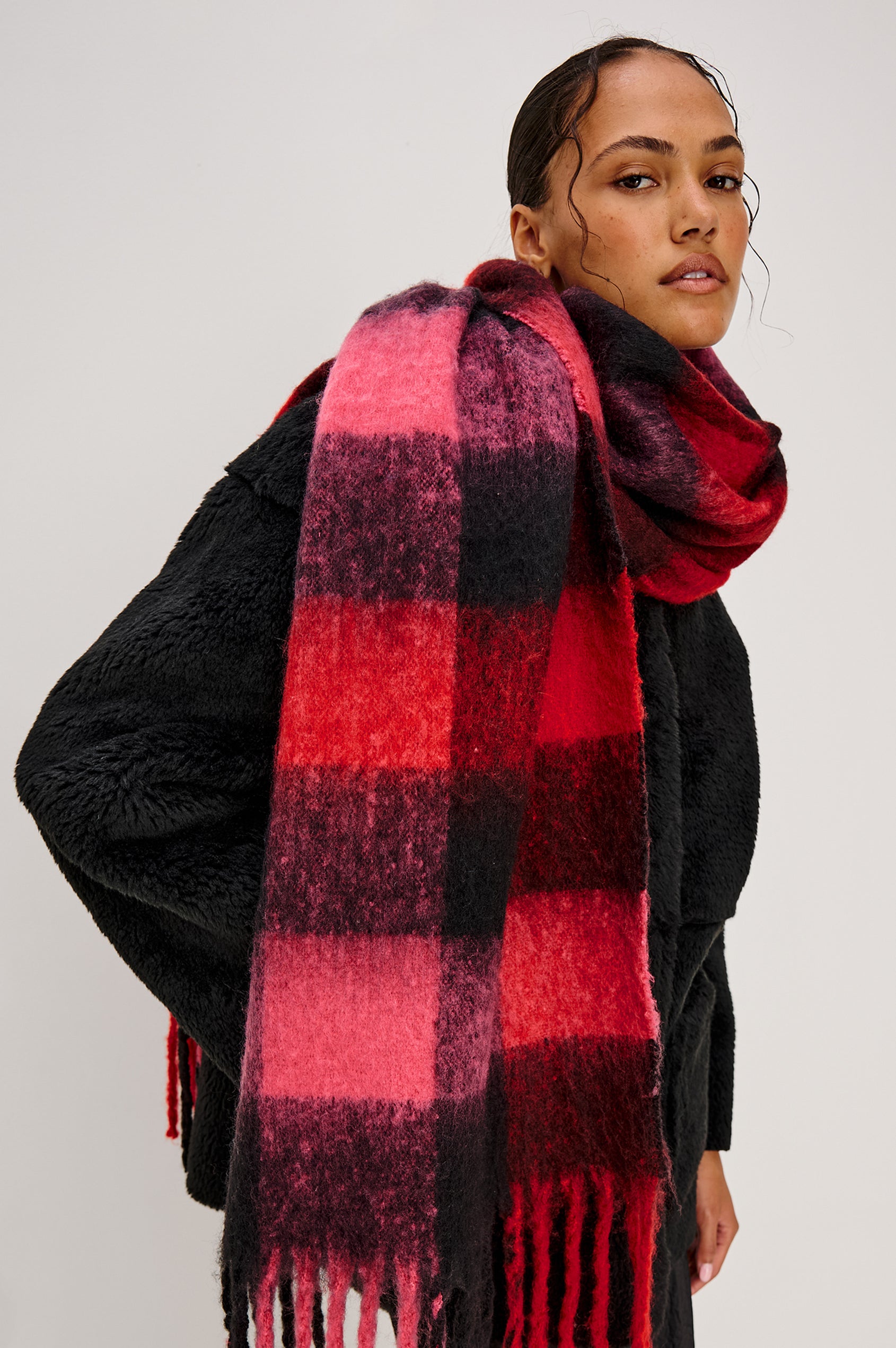 Oslo Scarf with Twisted Tassels and a Checkered Pattern in Charcoal Black Colorway - Front View Featured on Model