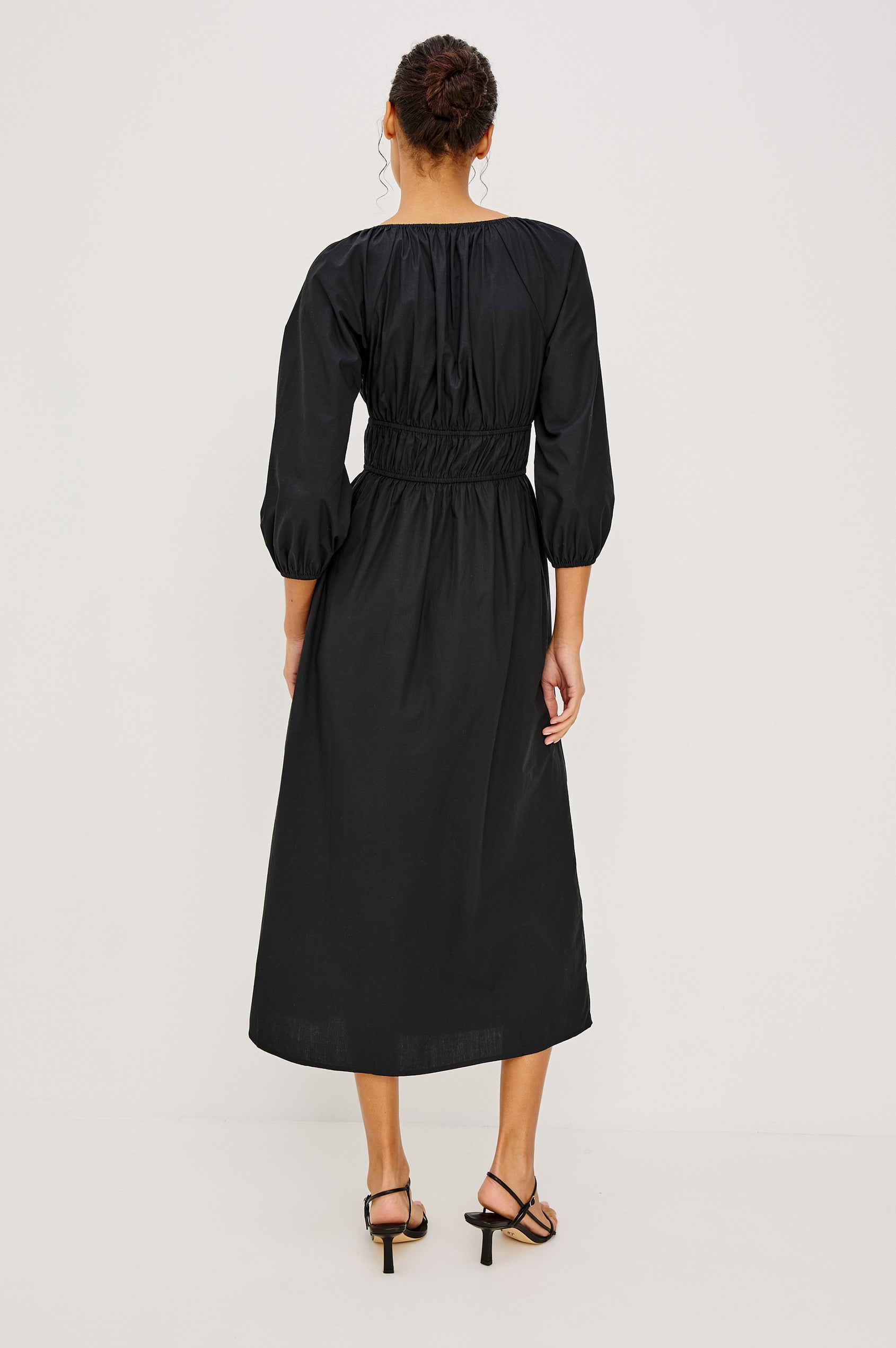 Paio Midi Dress in Crinkle Poplin With Elastic V-Neck, Waist, and Cuffs, Bust Keyhole Cut Out, and Three-Quarter Sleeves in Black Colorway - Full Body Back View Featured on Model