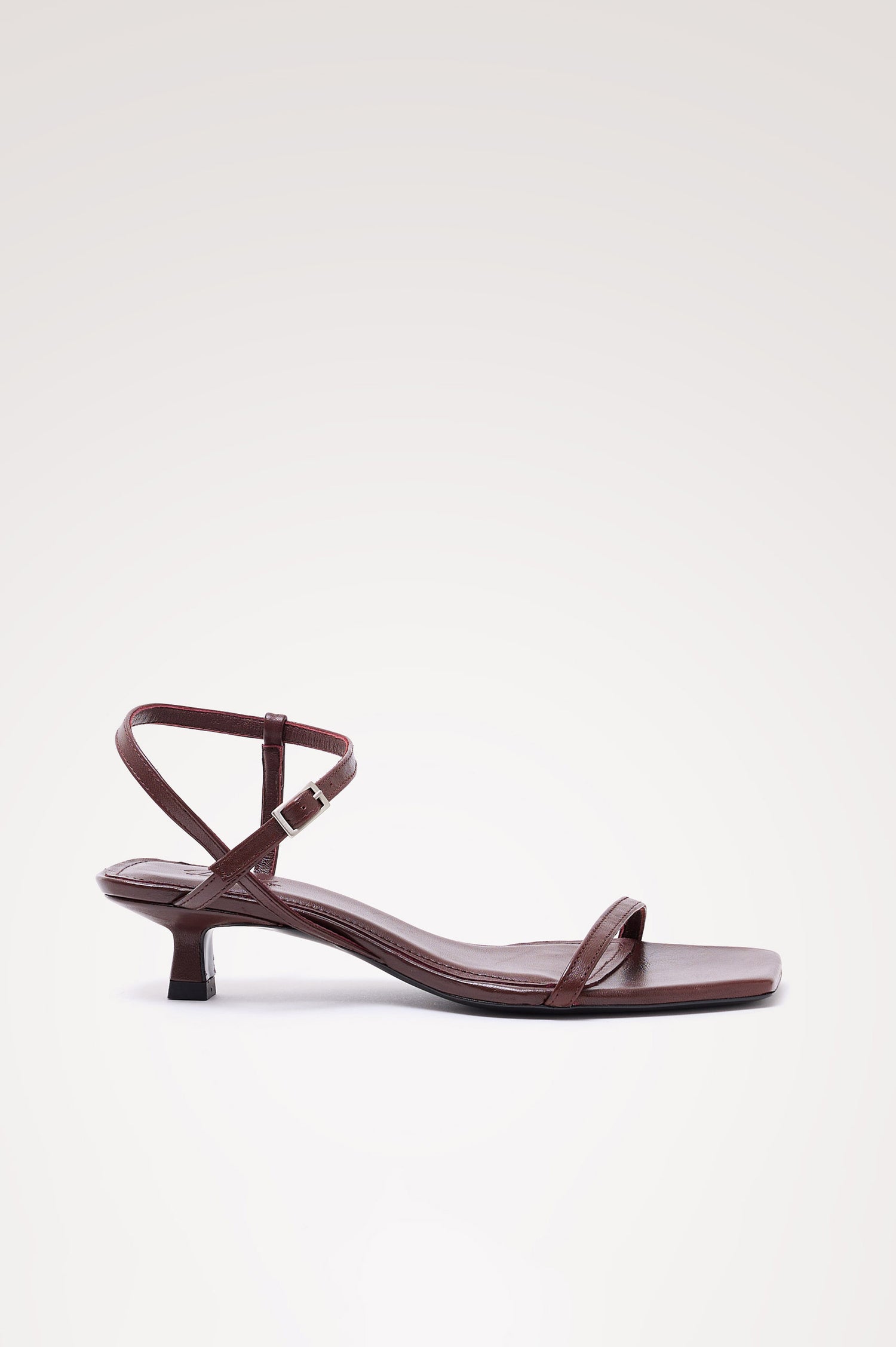 Palma Sandal Heel in Top-Grain Leather With Single Toe Strap, Adjustable Buckled Wrap Ankle Strap, and Low Heel in Burgundy Colorway - side view of shoe.