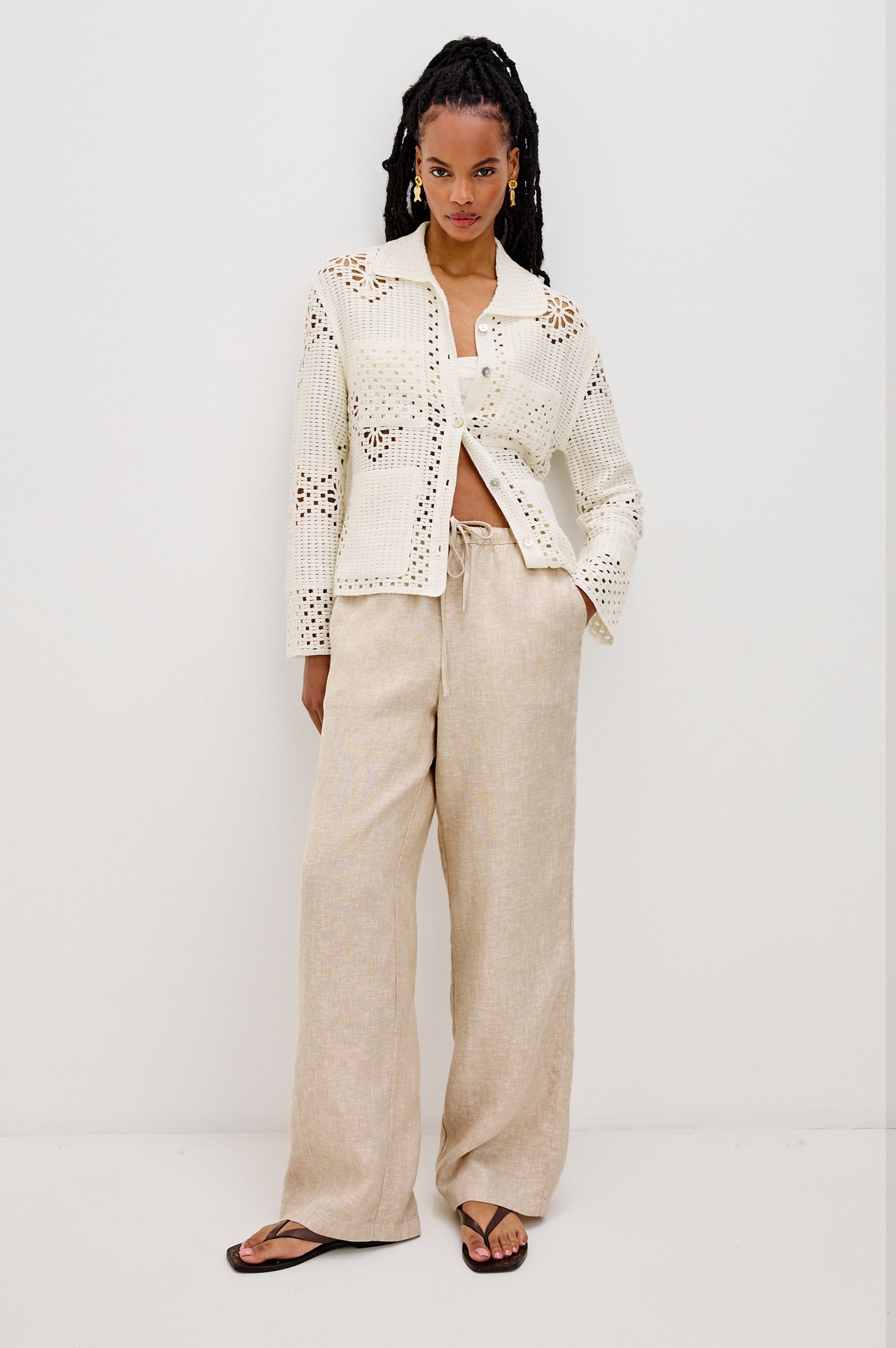 Patmos Collared Button Front Sweater Cardigan with Long Sleeves and Four Front Patch Pockets in Ivory Colorway. Front View Shown on Model.