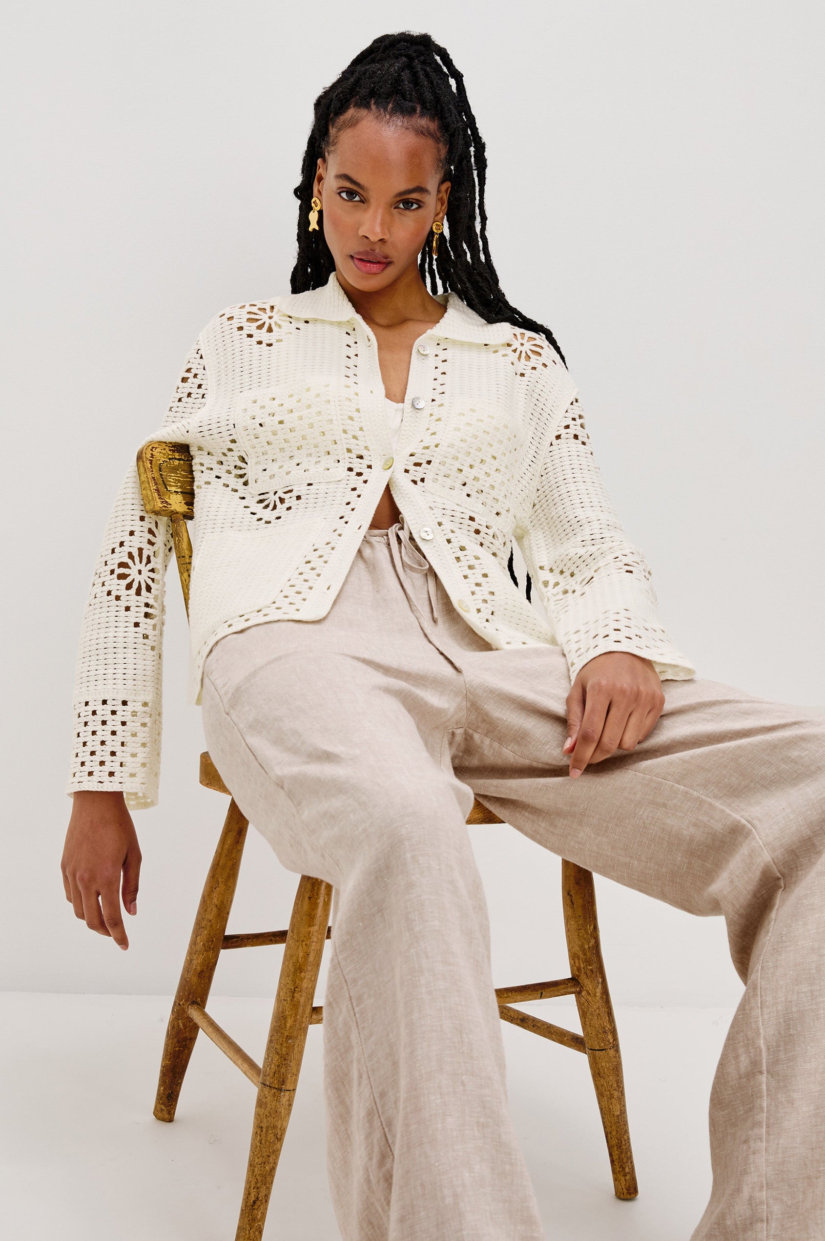 Patmos Collared Button Front Sweater Cardigan with Long Sleeves and Four Front Patch Pockets in Ivory Colorway. Front View Shown on Model.