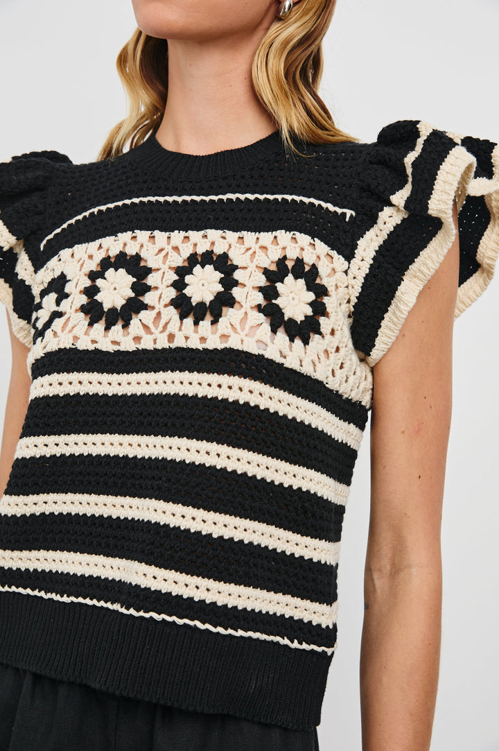 Penelope Crochet Top with Flutter Sleeves and Ribbed Hem in Black Ivory Stripe Colorway, Horizontal Stripes with Contrasting Knit Flowers Across the Chest - Front View Featured on Model