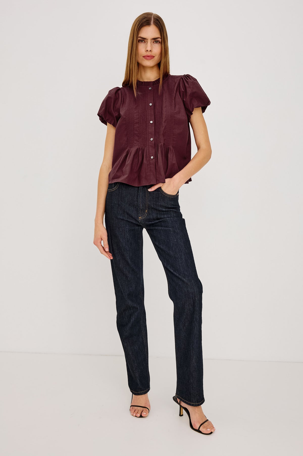Pepper Shirt in Cotton Poplin With Loose Boxy Fit, Pintuck Detailing, Puff Cap Sleeves, Center-Front Buttons, and Soft Peplum Hem in Port Colorway - Full Body Front View Featured on Model