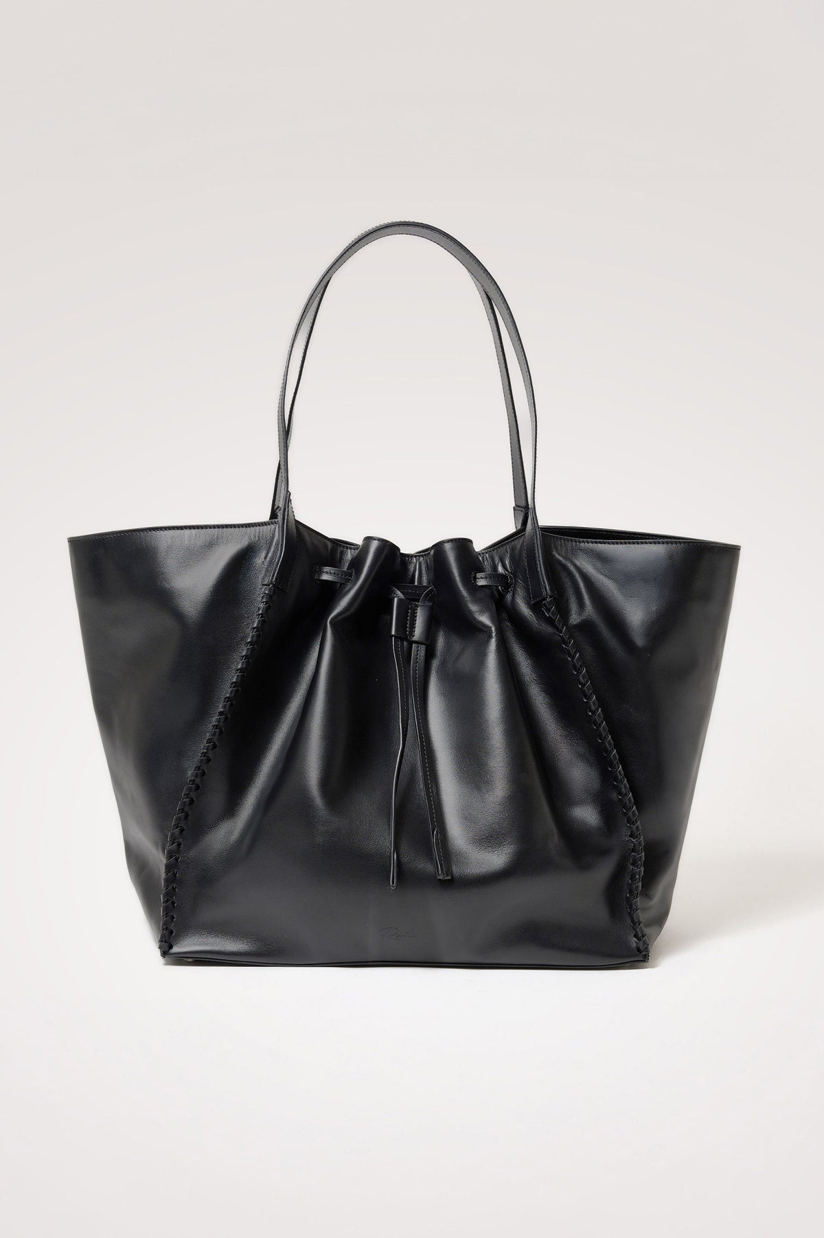 Prato Bucket Tote in Leather With Whipstitch Trim, Fixed Top Straps, Drawcord Closure, Interior Zip Pocket, Interior Slip Pocket in Black Colorway - Front Product View Featured