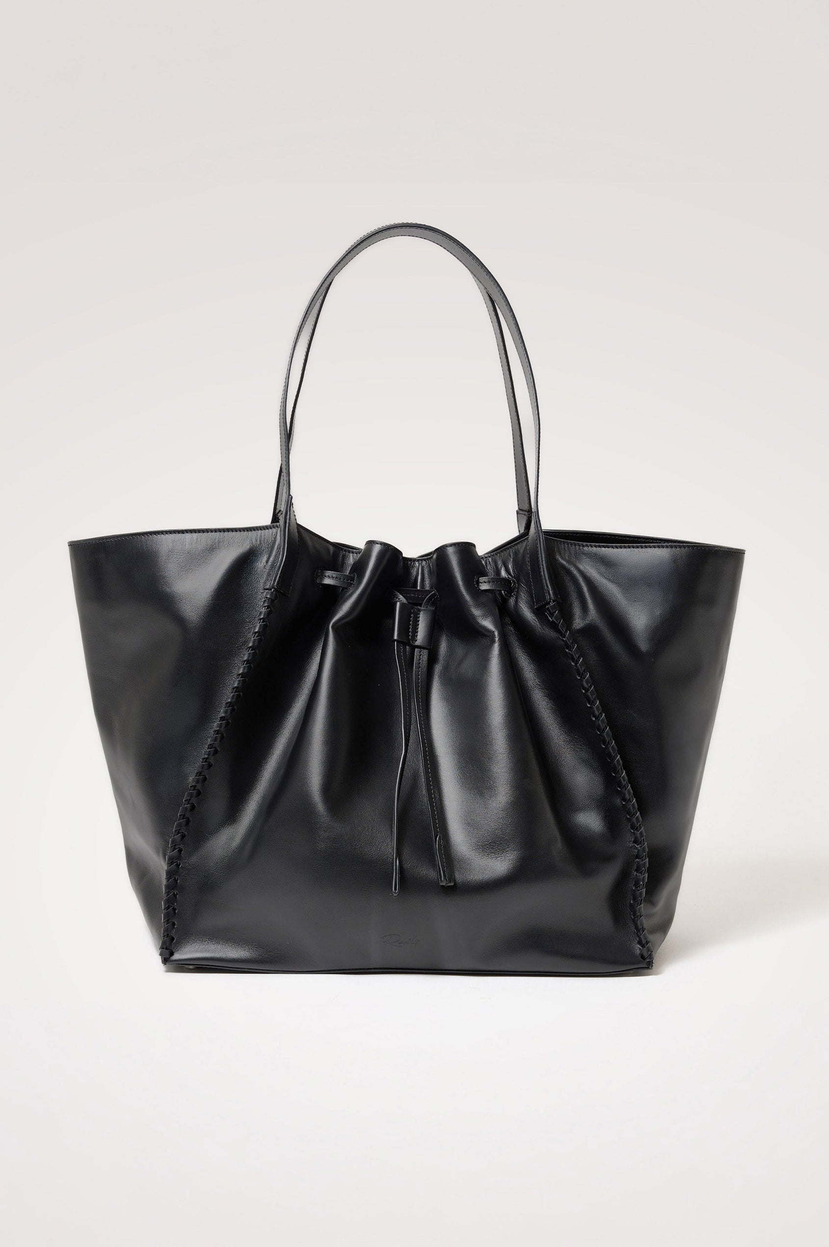Prato Bucket Tote in Leather With Whipstitch Trim, Fixed Top Straps, Drawcord Closure, Interior Zip Pocket, Interior Slip Pocket in Black Colorway - Front Product View Featured