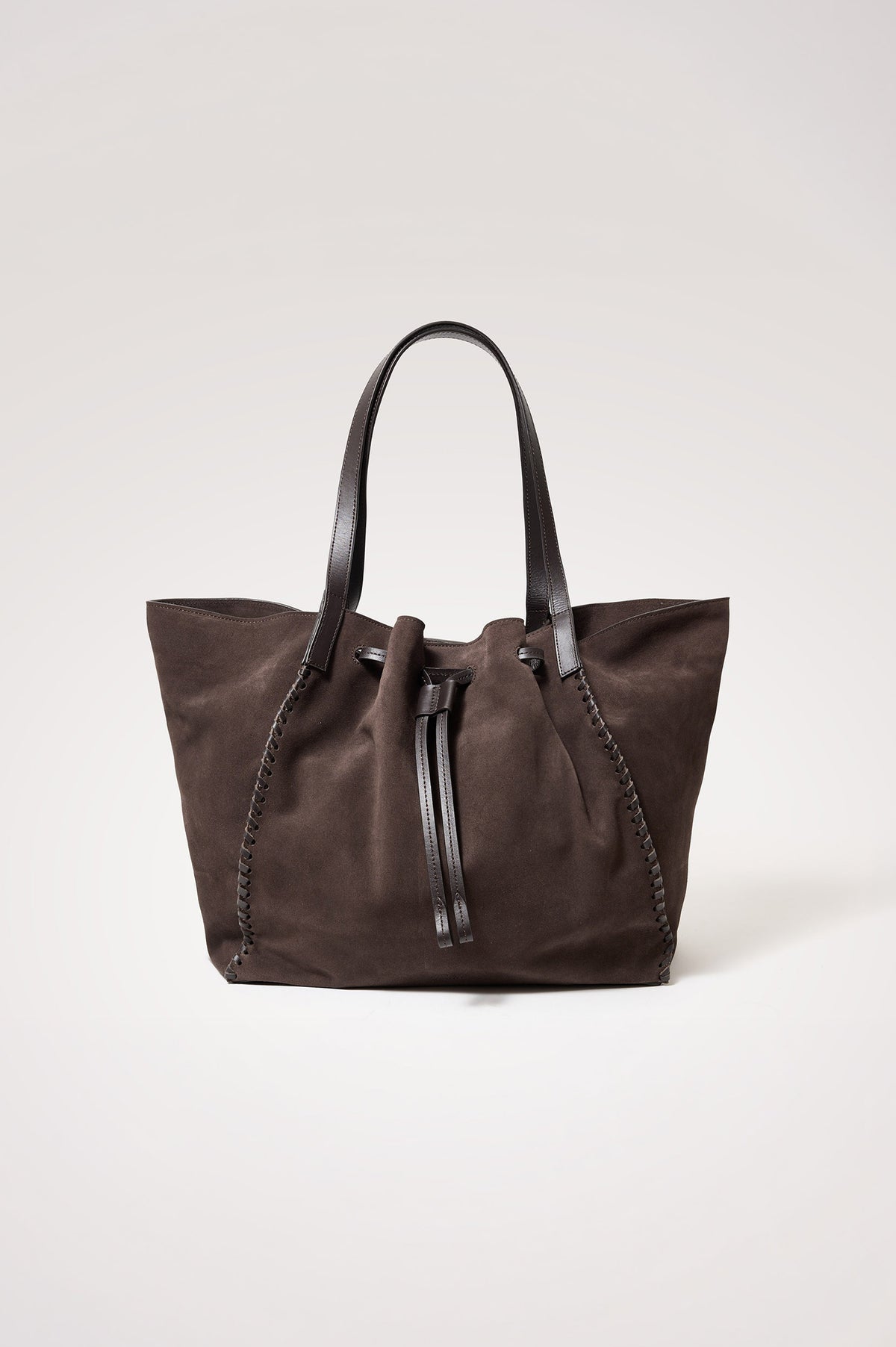 Prato Bucket Tote in Suede With Whipstitch Trim, Fixed Top Straps, Drawcord Closure, Interior Zip Pocket, Interior Slip Pocket in Dark Brown Suede Colorway - Front Product View Featured