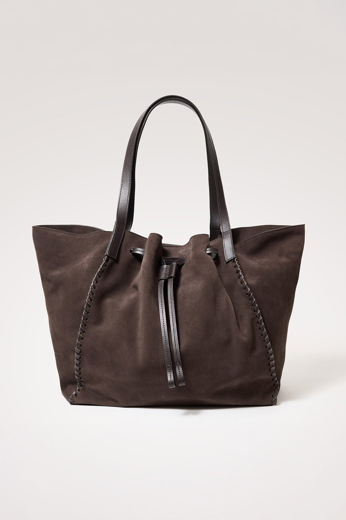 Prato Bucket Tote in Suede With Whipstitch Trim, Fixed Top Straps, Drawcord Closure, Interior Zip Pocket, Interior Slip Pocket in Dark Brown Suede Colorway - Front Product View Featured