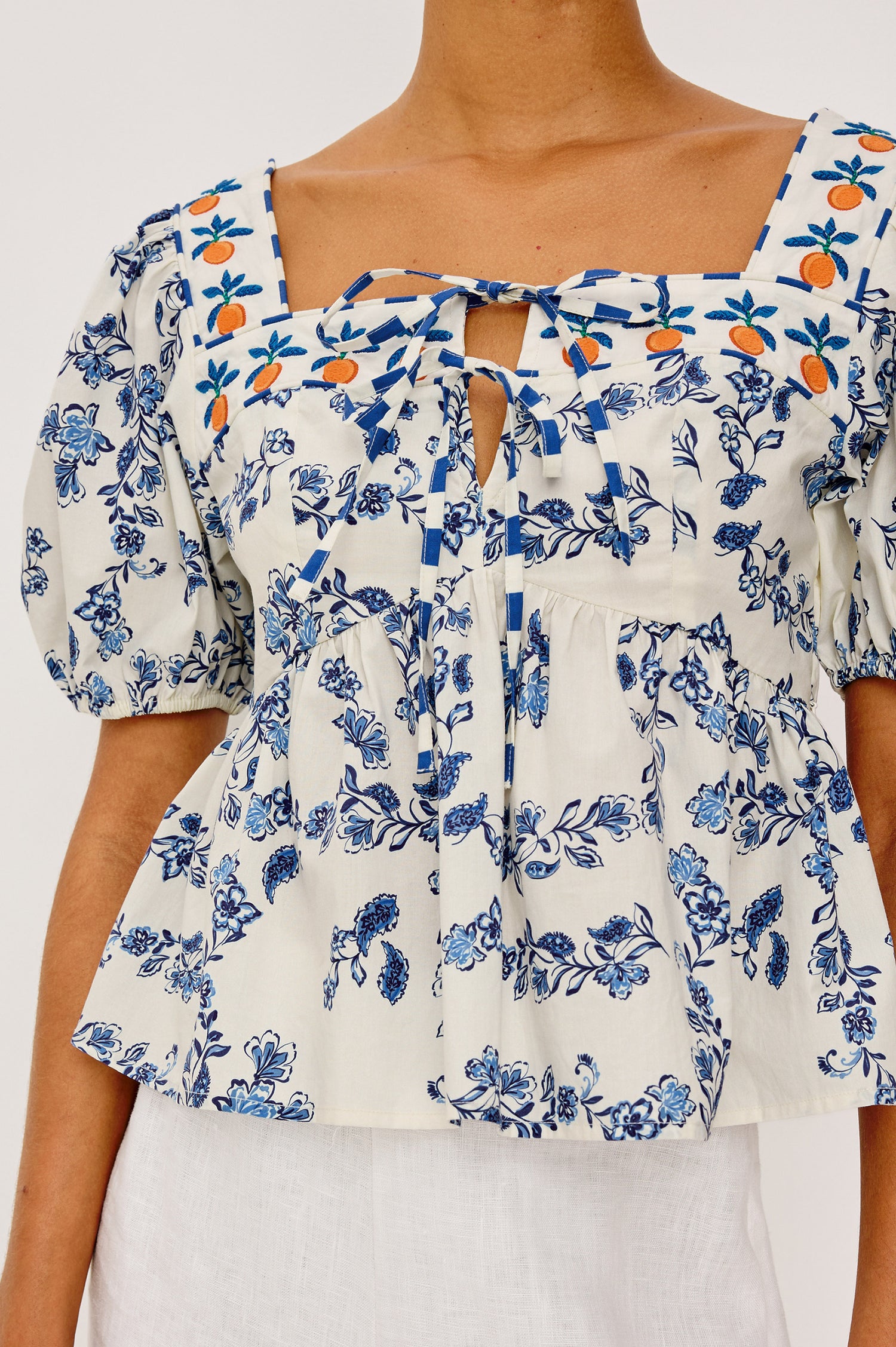 Presley Top in Cotton Poplin With Square Neckline, Short Puff Sleeves, Embroidered Oranges, and Darts for Shaping in Ceramic Floral Colorway - Upper Body Front View Featured on Model
