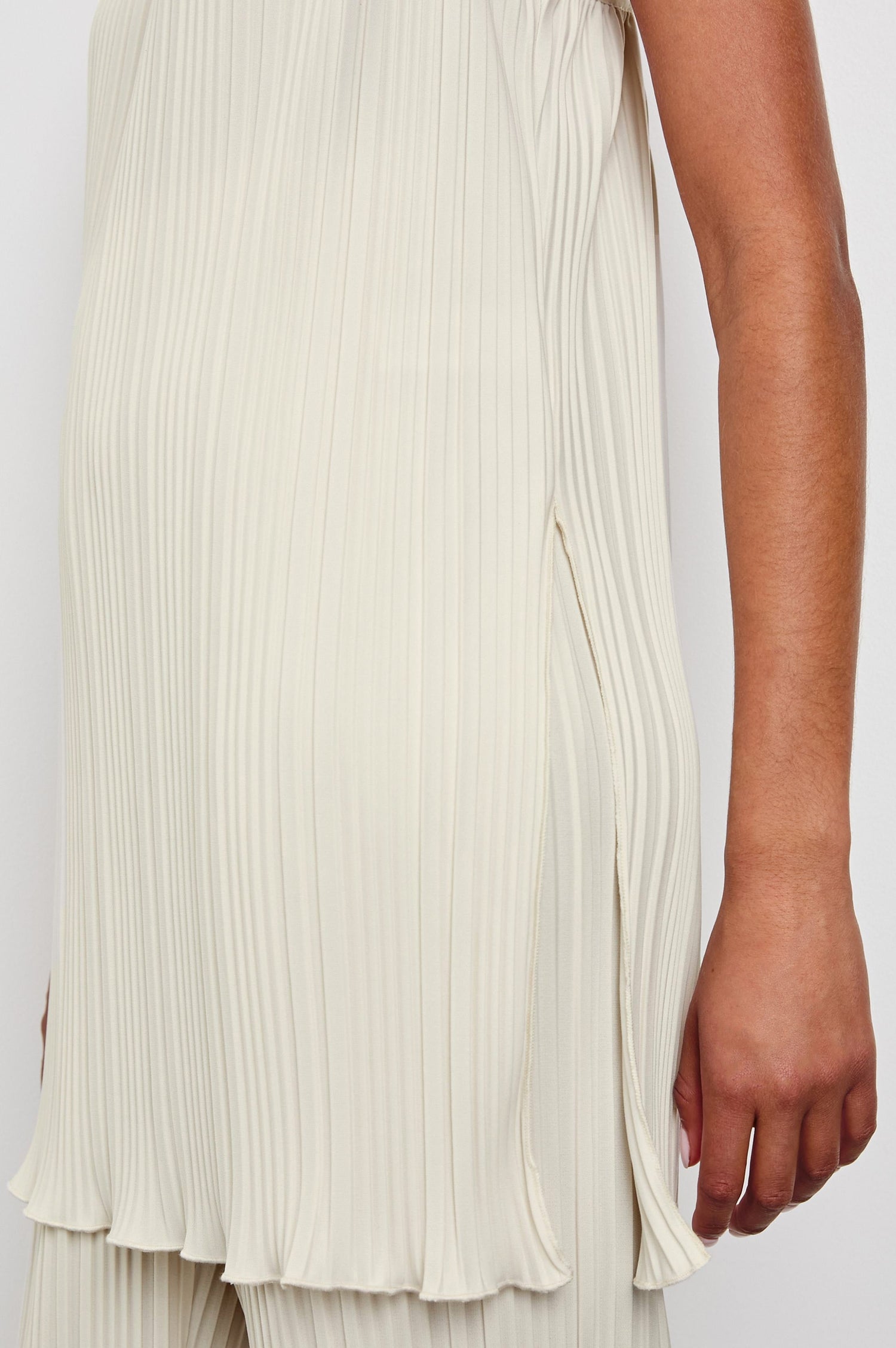 Rachel Sleeveless Ribbed Top with Adjustable Spaghetti Straps, a Scoop Neck, Baby Doll Fit and Side Slits in Ivory Colorway - Front View Featured on Model