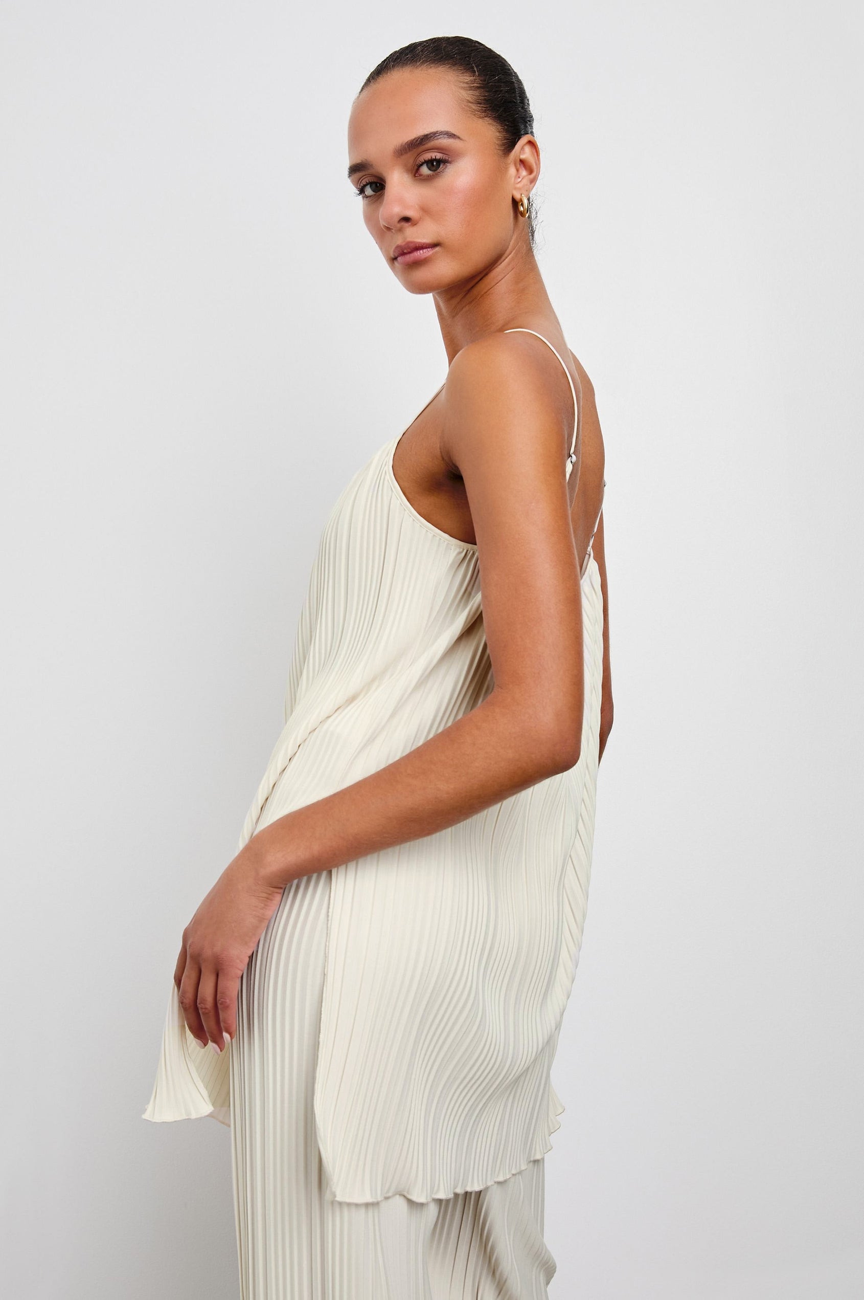 Rachel Sleeveless Ribbed Top with Adjustable Spaghetti Straps, a Scoop Neck, Baby Doll Fit and Side Slits in Ivory Colorway - Side View Featured on Model