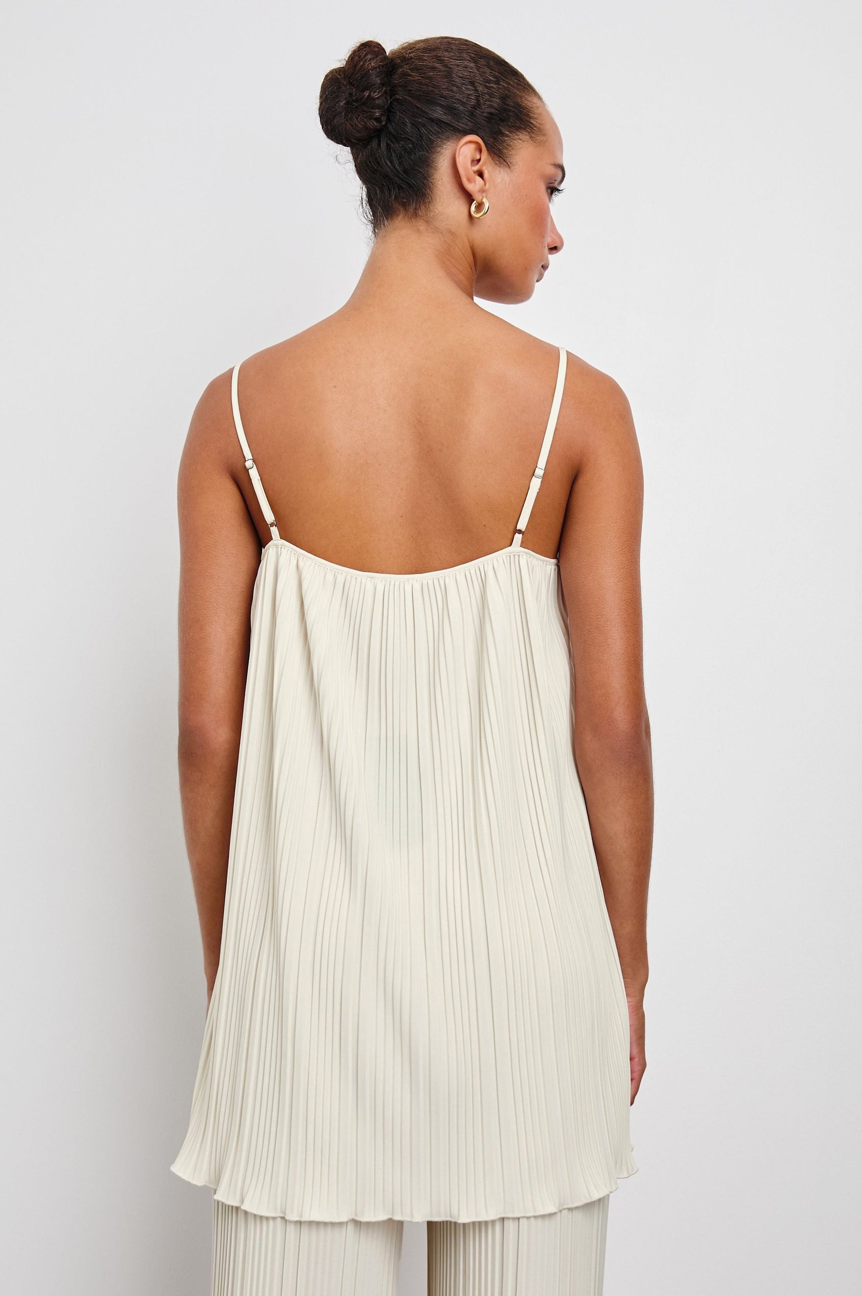 Rachel Sleeveless Ribbed Top with Adjustable Spaghetti Straps, a Scoop Neck, Baby Doll Fit and Side Slits in Ivory Colorway - Back View Featured on Model