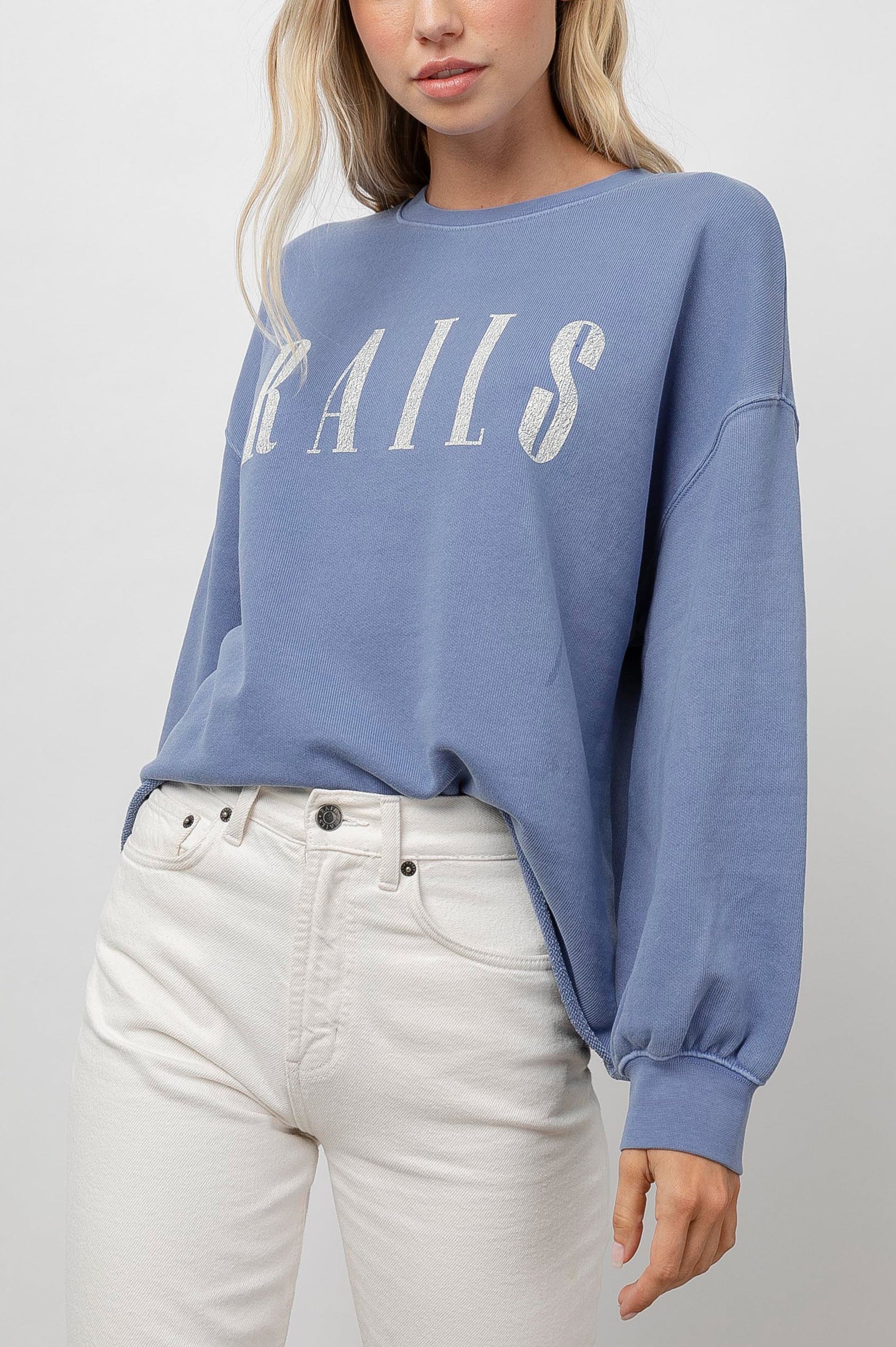 Rails Signature Long-Sleeve Sweatshirt with a Crew Neck, Raw Hem, Shirring Above Cuff, and the Text, Rails, in Washed Indigo Rails Colorway, with Ivory Text - Front View Featured on Model 