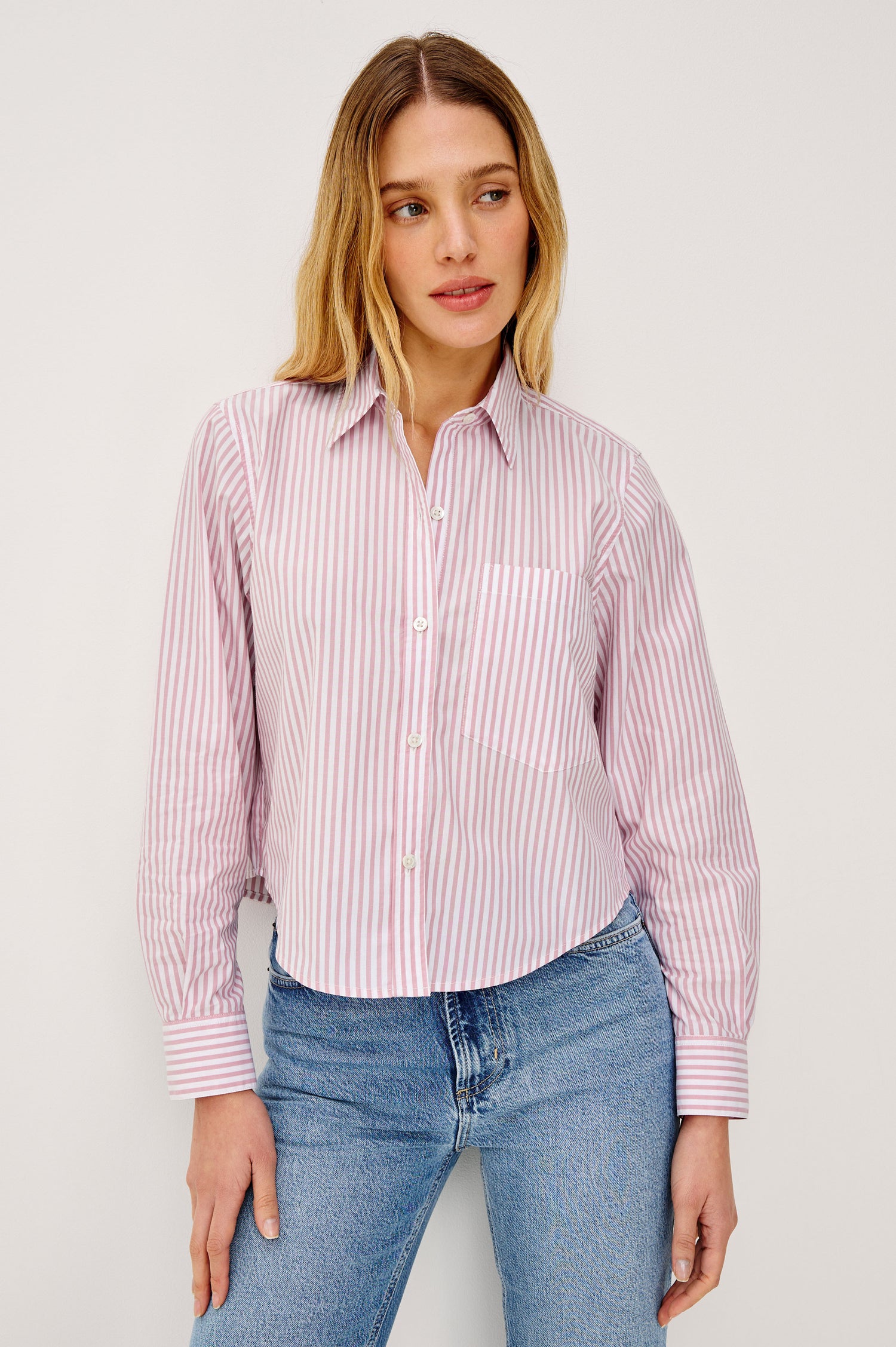 Ramy Cropped Button-Up Shirt in Cotton Poplin With Collar, Front Buttons, and Long Sleeves in Rose Stripe Colorway - Upper Body Front View Featured on Model