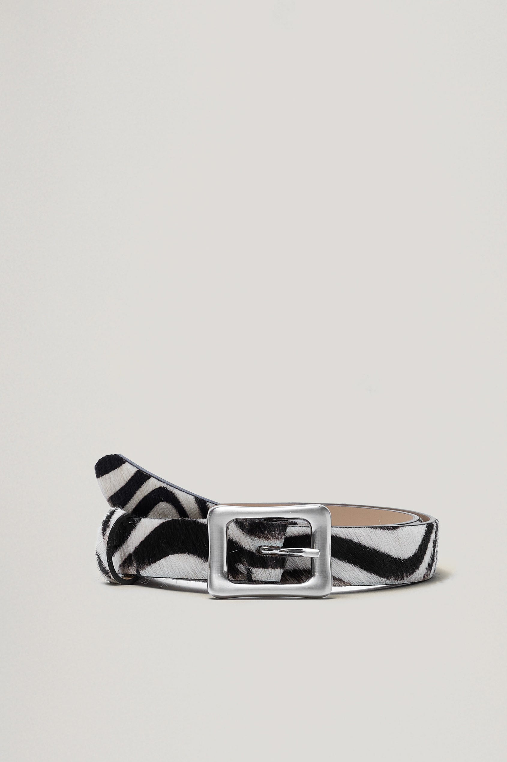 Remi Belt with a Rectangular Buckle with Rounded Corners in black and white zebra Colorway, and Silver-tone Buckle - Front View, flat, not on model.