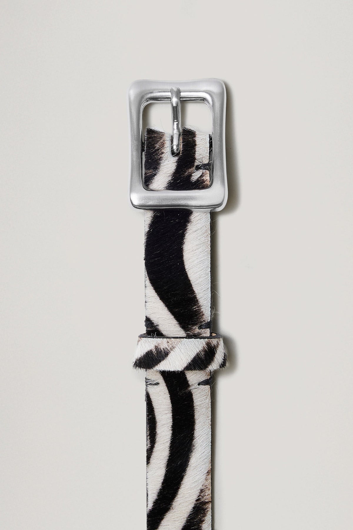 Remi Belt with a Rectangular Buckle with Rounded Corners in black and white zebra Colorway, and Silver-tone Buckle - Front View, flat, not on model.