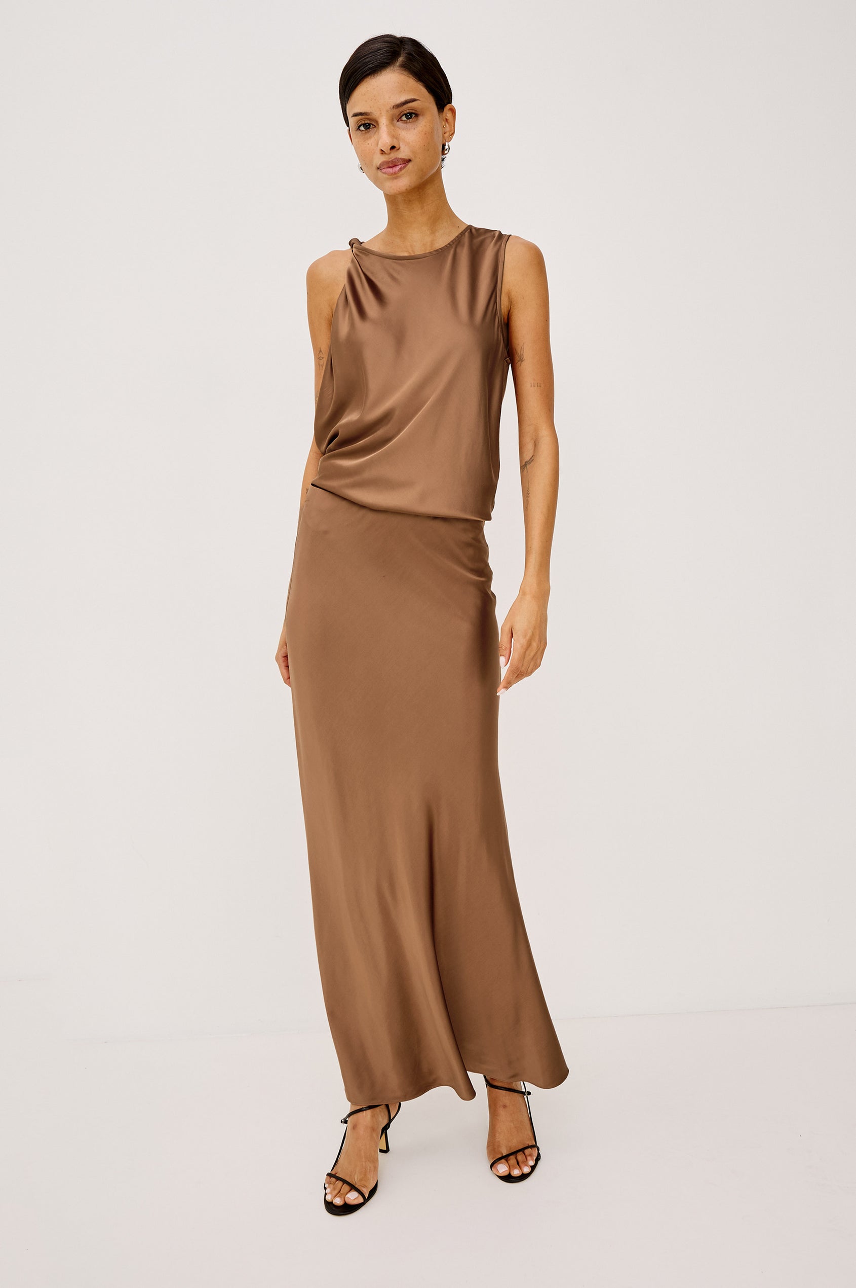 Robin Sleeveless Tank Shirt in Satin With Round Neck, Twisted Shoulder Strap, and Relaxed Fit in Cinnamon Colorway - Full Body Front View Featured on Model