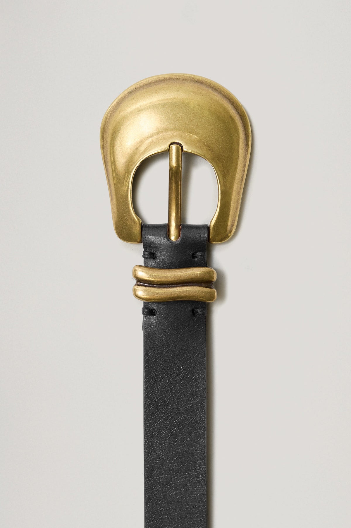 Rodeo black leather belt featuring a western-style engraved gold buckle and hardware. Front view of belt featured not on model.